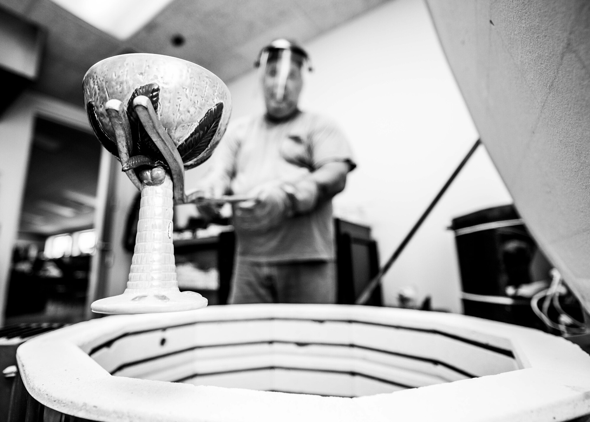 Hank Hangsleben, Arts and Crafts Center recreation assistant, removes a finished piece from the kiln at Holloman Air Force Base, N.M., Aug 22. The Arts and Crafts Center offers pottery classes by appointment Monday through Friday during normal business hours of 10 a.m. to 5 p.m. Hangsleben, an expert potter, studied under the tutelage of world-renowned artists in Japan and Hawaii and uses state of the art pottery equipment to instruct his students. 