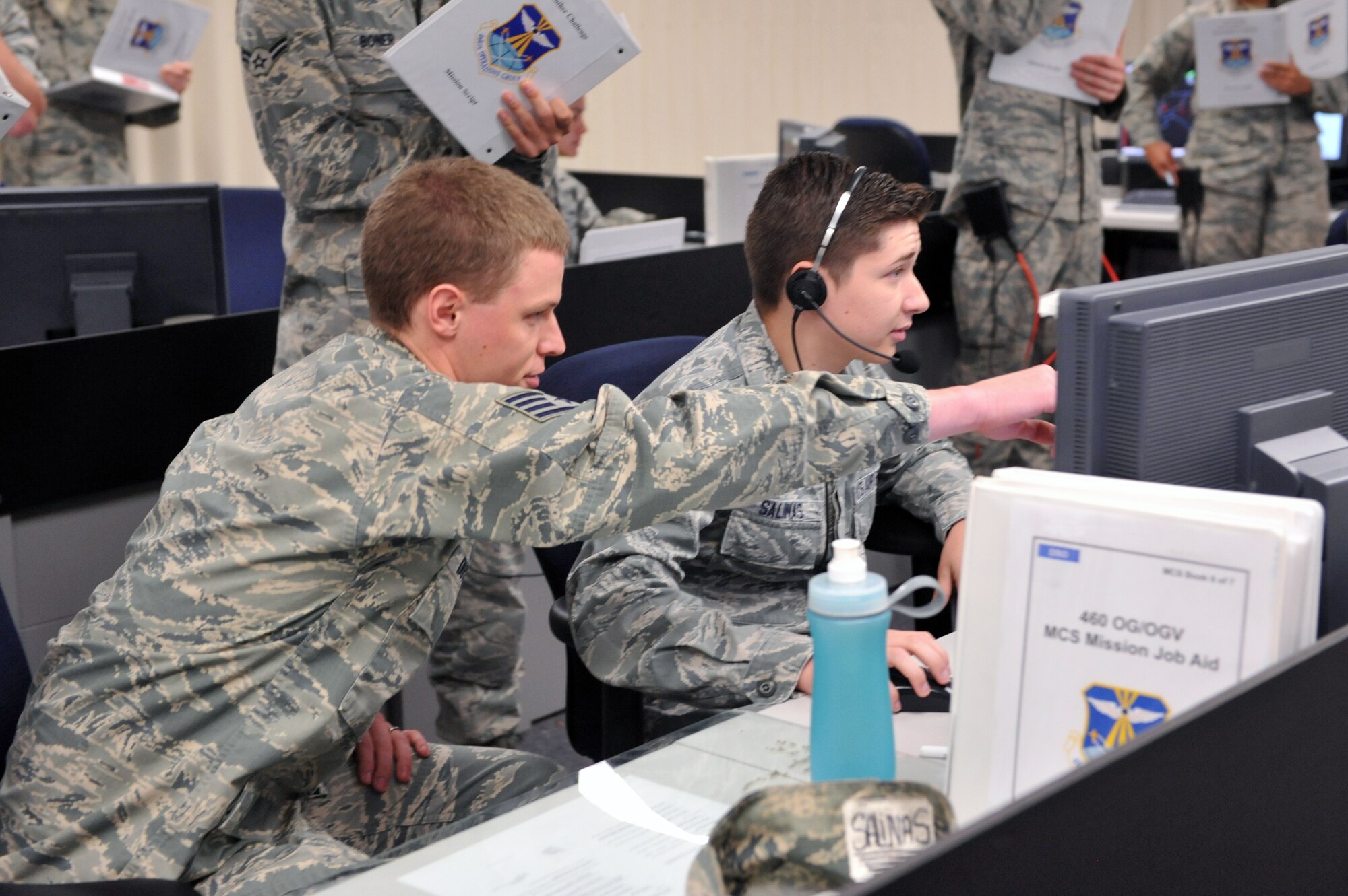 Staff Sgt. Dale Duxbury, 2nd Space Warning Squadron mission crew chief, (left) and Airman 1st Class Jacob Salinas, 2nd Space Warning Squadron data systems operator, work together during the 460th Operations Group Panther Challenge on Buckley Air Force Base, Colo. The challenge, held Aug. 4-13, was developed to provide members of Team Buckley an opportunity to improved their skills and expand their job knowledge in a competitive setting. Participants in the challenge included the 2nd and 8th Space Warning Squadrons, 460th Security Forces Squadron, and 460th Medical Group. (U.S. Air Force photo by Airman Emily E. Amyotte/Released)