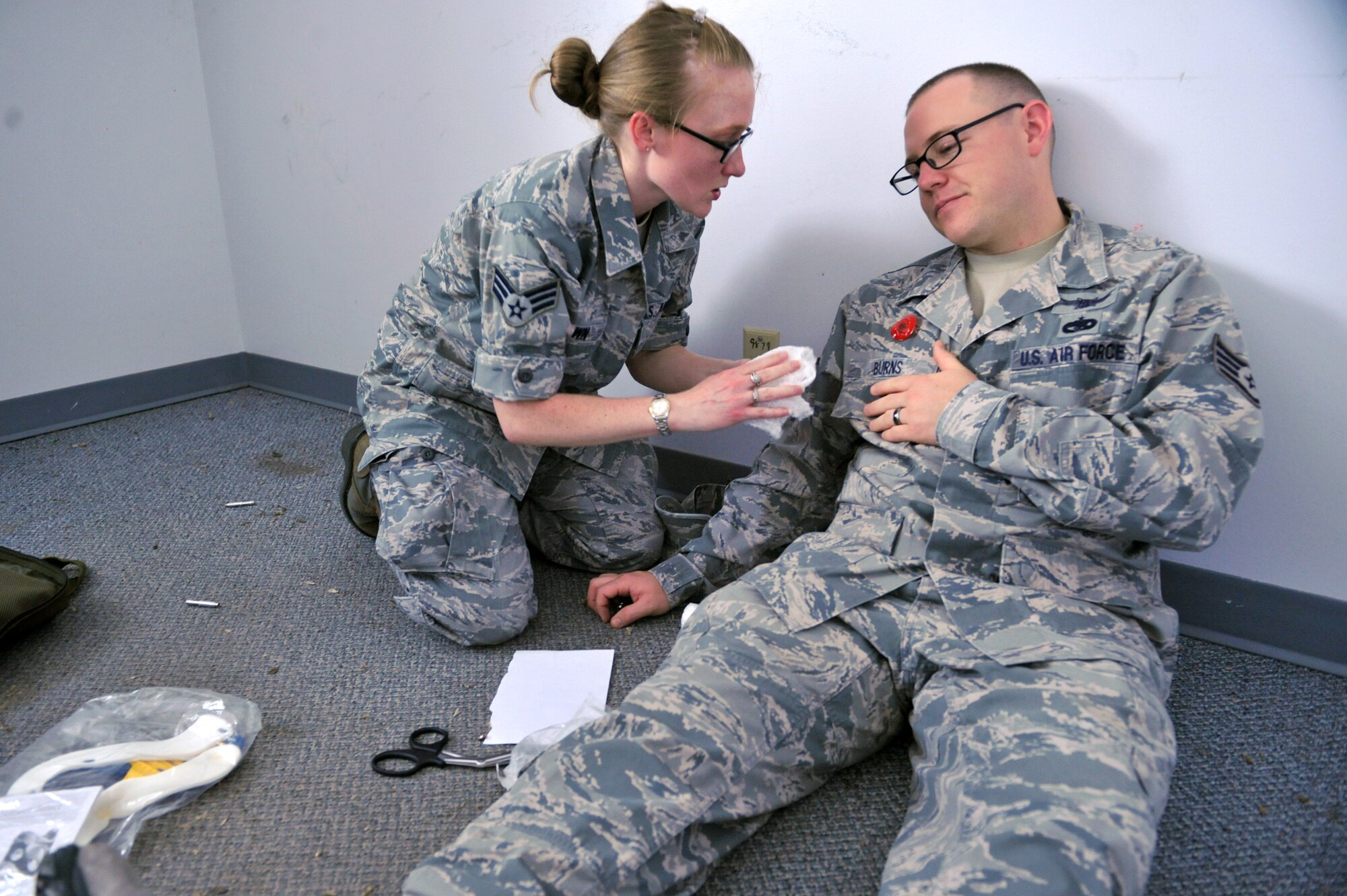 An Airman from the 460th Medical Group, assists Staff Sgt. Nicholas Burns, 2nd Space Warning Squadron mission crew chief, and his simulated injuries as part of the Panther Challenge Aug. 13, 2014, on Buckley Air Force Base, Colo. The challenge, held Aug. 4-13, was developed to provide members of Team Buckley an opportunity to improved their skills and expand their job knowledge in a competitive setting. Participants in the challenge included the 2nd and 8th Space Warning Squadrons, 460th Security Forces Squadron, and 460th Medical Group. (U.S. Air Force photo by Airman Emily E. Amyotte)