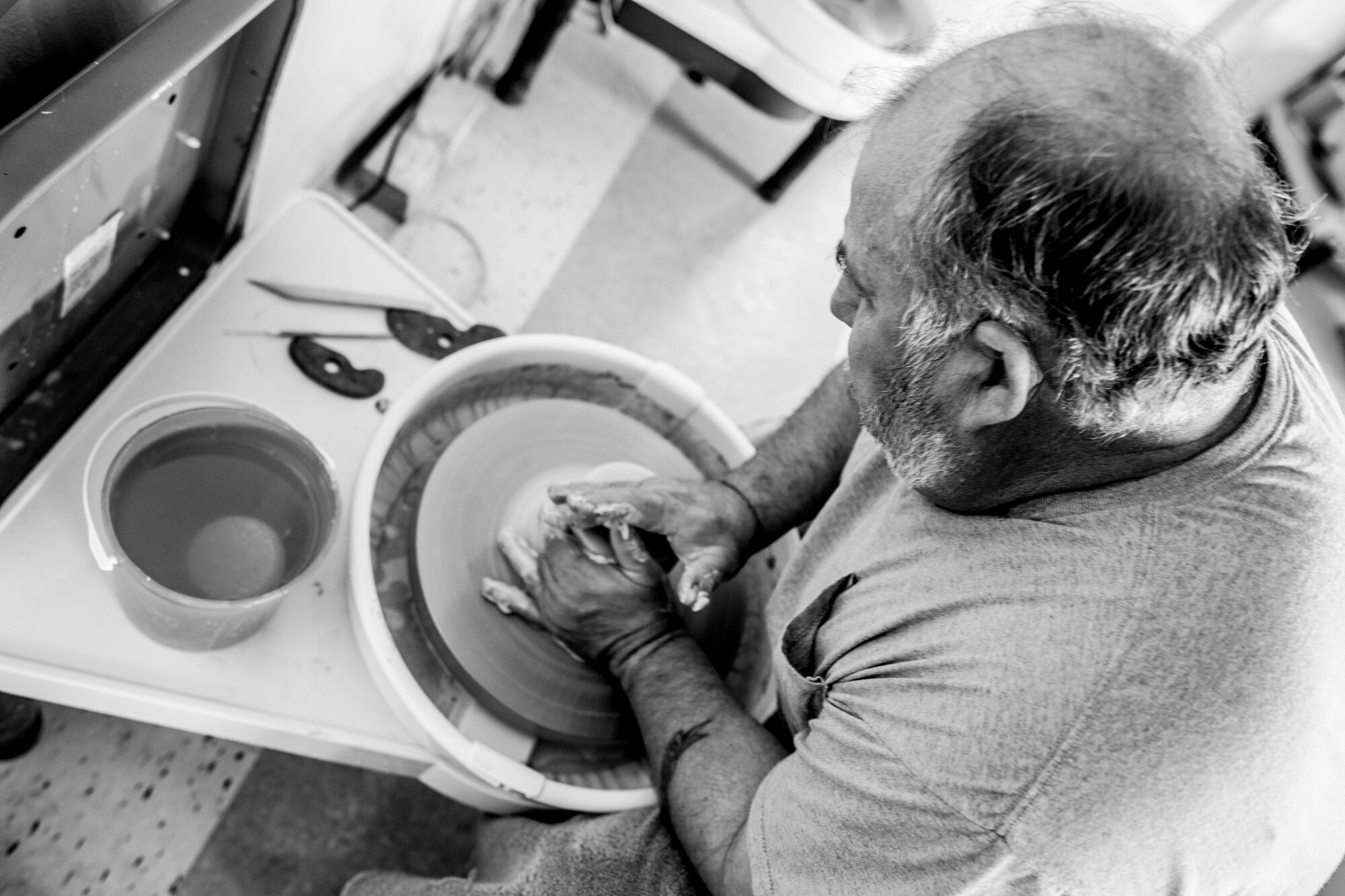 Hank Hangsleben, Arts and Crafts Center recreation assistant, throws clay on the pottery wheel at Holloman Air Force Base, N.M., Aug 22. The Arts and Crafts Center offers pottery classes by appointment Monday through Friday during normal business hours of 10 a.m. to 5 p.m. Hangsleben, an expert potter, studied under the tutelage of world-renowned artists in Japan and Hawaii and uses state of the art pottery equipment to instruct his students. 