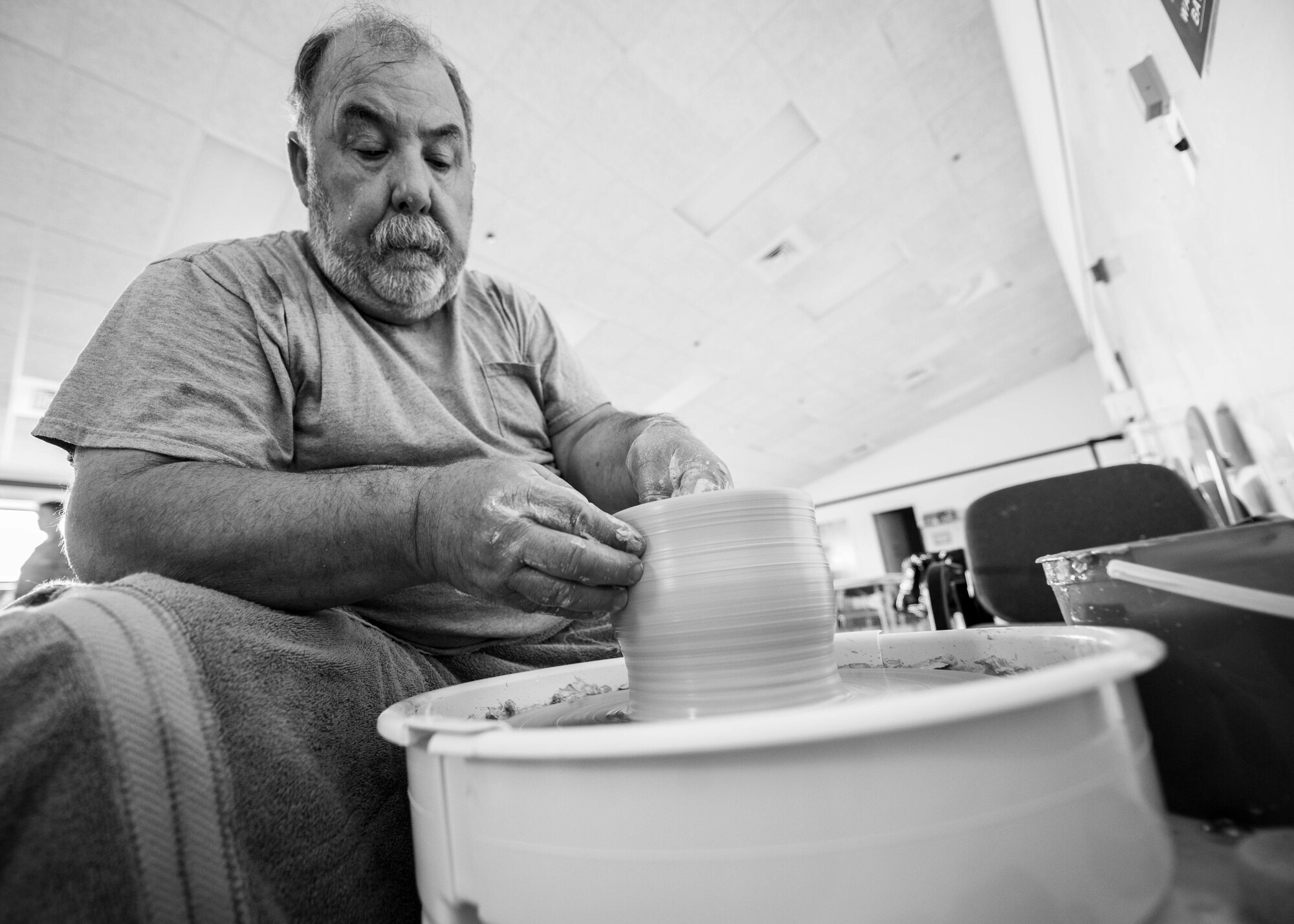 Hank Hangsleben, Arts and Crafts Center recreation assistant, throws clay on the pottery wheel at Holloman Air Force Base, N.M., Aug 22. The Arts and Crafts Center offers pottery classes by appointment Monday through Friday during normal business hours of 10 a.m. to 5 p.m. Hangsleben, an expert potter, studied under the tutelage of world-renowned artists in Japan and Hawaii and uses state of the art pottery equipment to instruct his students. 