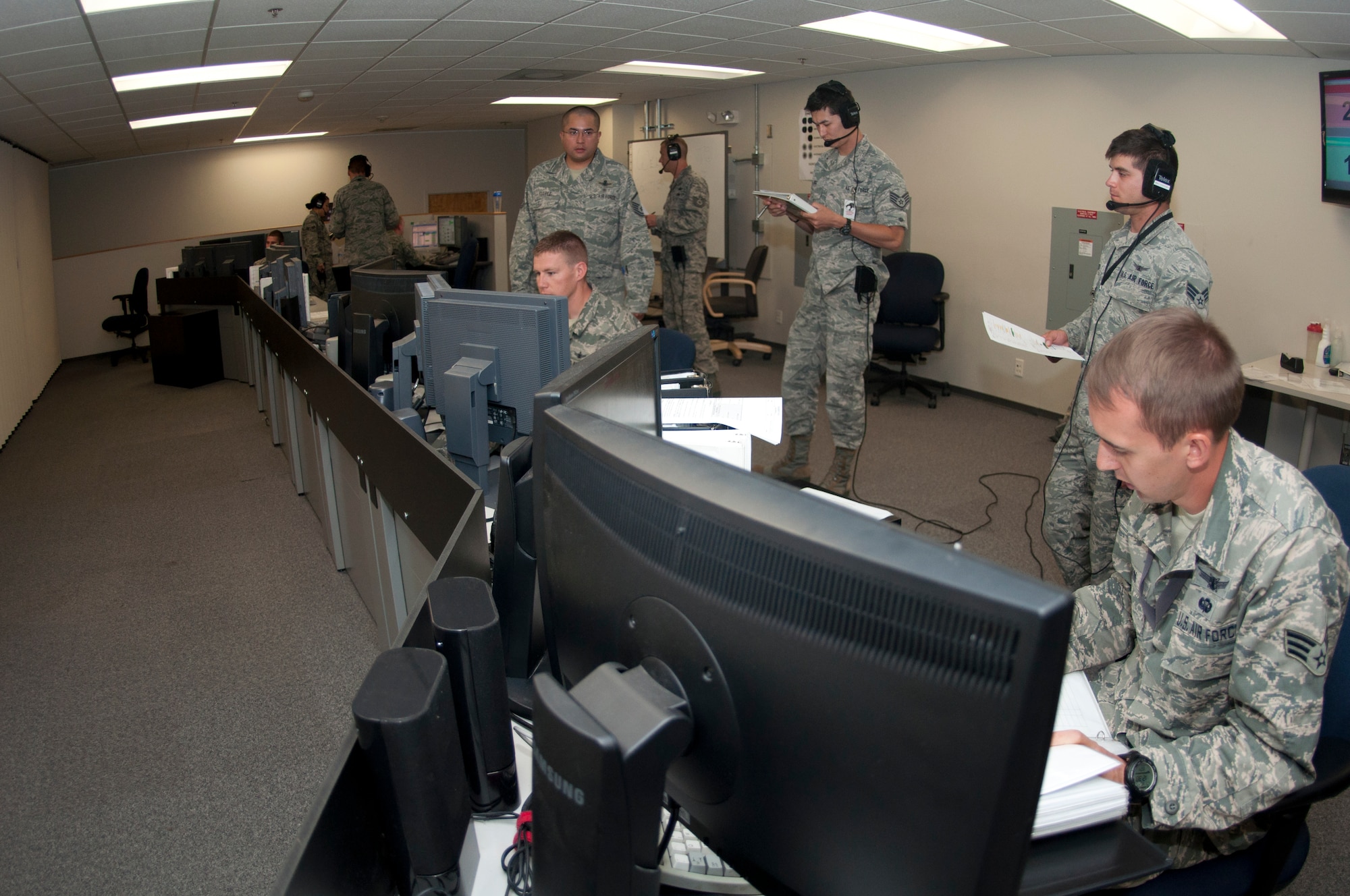 Members of the 8th Space Warning Squadron respond to various simulated incidents while being evaluated by members of the 460th Operations Support Squadron during the 460th Operations Group Panther Challenge Aug. 4, 2014, on Buckley Air Force Base, Colo. The challenge, held Aug. 4-13, was developed to provide members of Team Buckley an opportunity to improve their skills and expand their job knowledge in a competitive setting. Participants in the challenge included the 2nd and 8th Space Warning Squadrons, 460th Security Forces Squadron, and 460th Medical Group. (U.S. Air Force photo by Tech. Sgt. Kali L. Gradishar/Released)