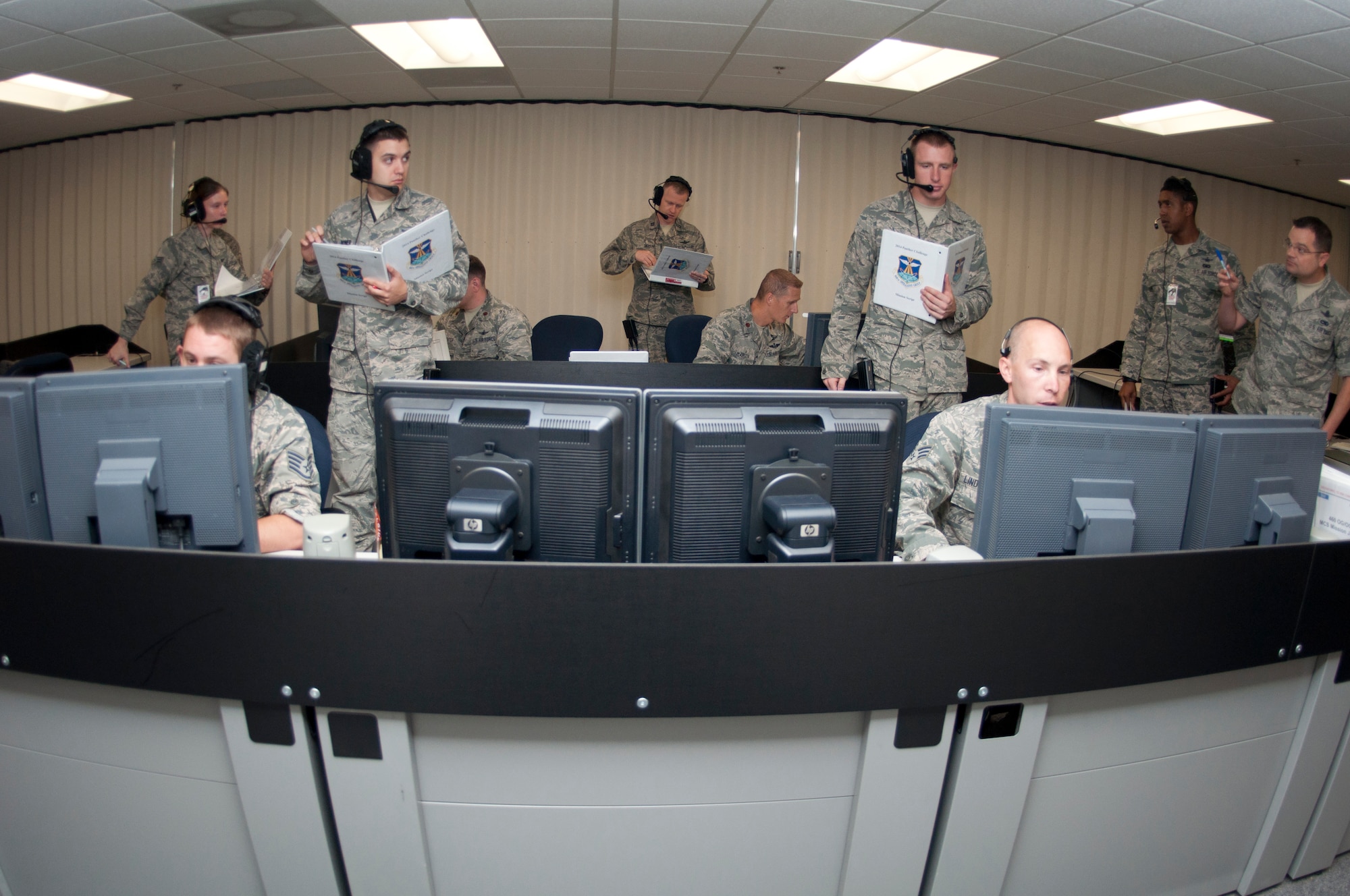 Members of the 8th Space Warning Squadron respond to simulated events while being evaluated by members of the 460th Operations Support Squadron during the 460th Operations Group Panther Challenge Aug. 4, 2014, on Buckley Air Force Base, Colo. The challenge, held Aug. 4-13, was developed to provide members of Team Buckley an opportunity to improve their skills and expand their job knowledge in a competitive setting. Participants in the challenge included the 2nd and 8th Space Warning Squadrons, 460th Security Forces Squadron, and 460th Medical Group. (U.S. Air Force photo by Tech. Sgt. Kali L. Gradishar/Released)
