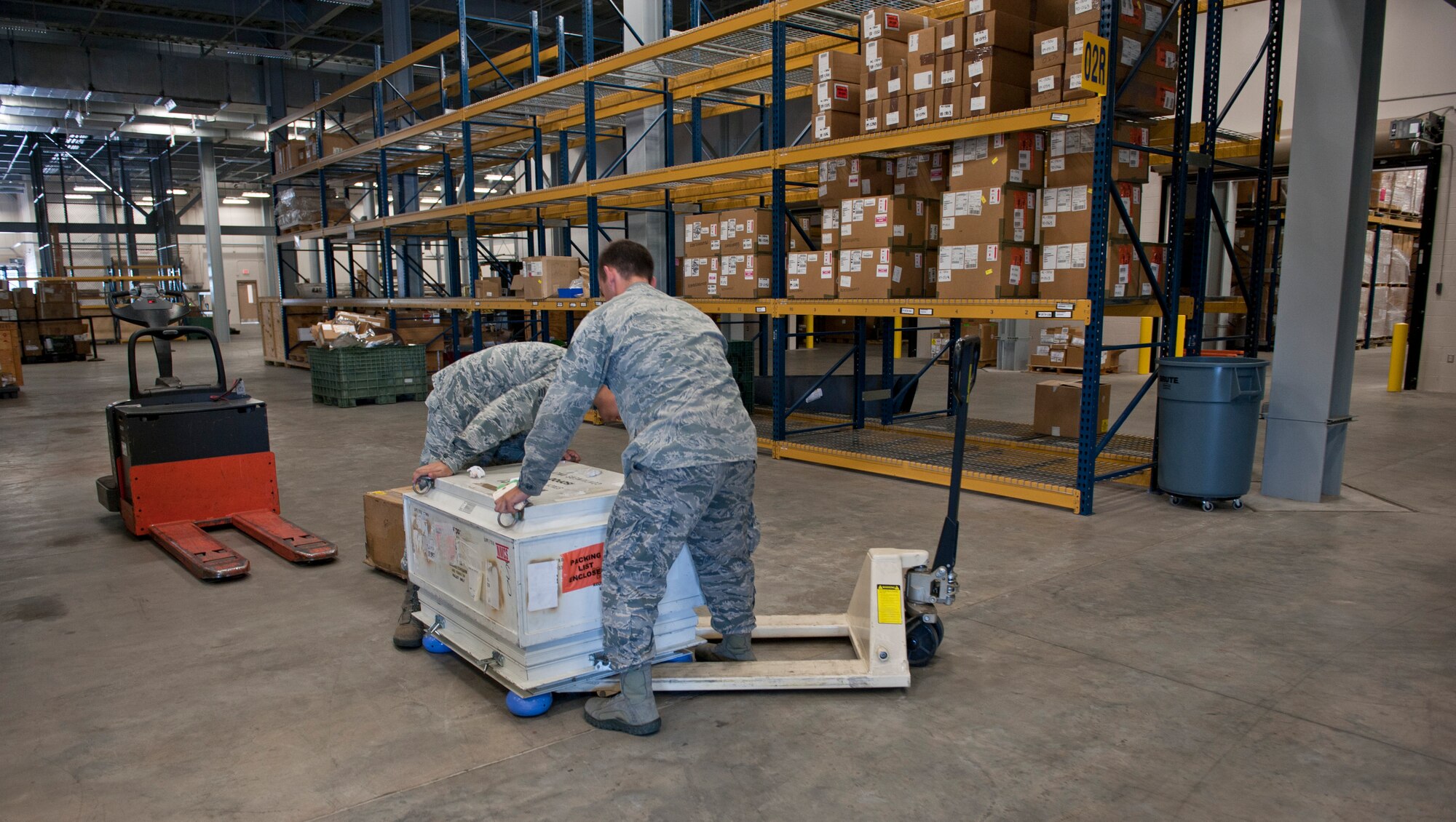 Senior Airmen Andrew Kanter and Matthew Stilwell, 1st Special Operations Logistic Readiness Squadron supply journeymen, move a radar transmitter at Hurlburt Field, Fla., Aug. 22, 2014. Maintenance squadrons are the biggest customers of the 1st SOLRS. (U.S. Air Force photo/Senior Airman Krystal M. Garrett) 