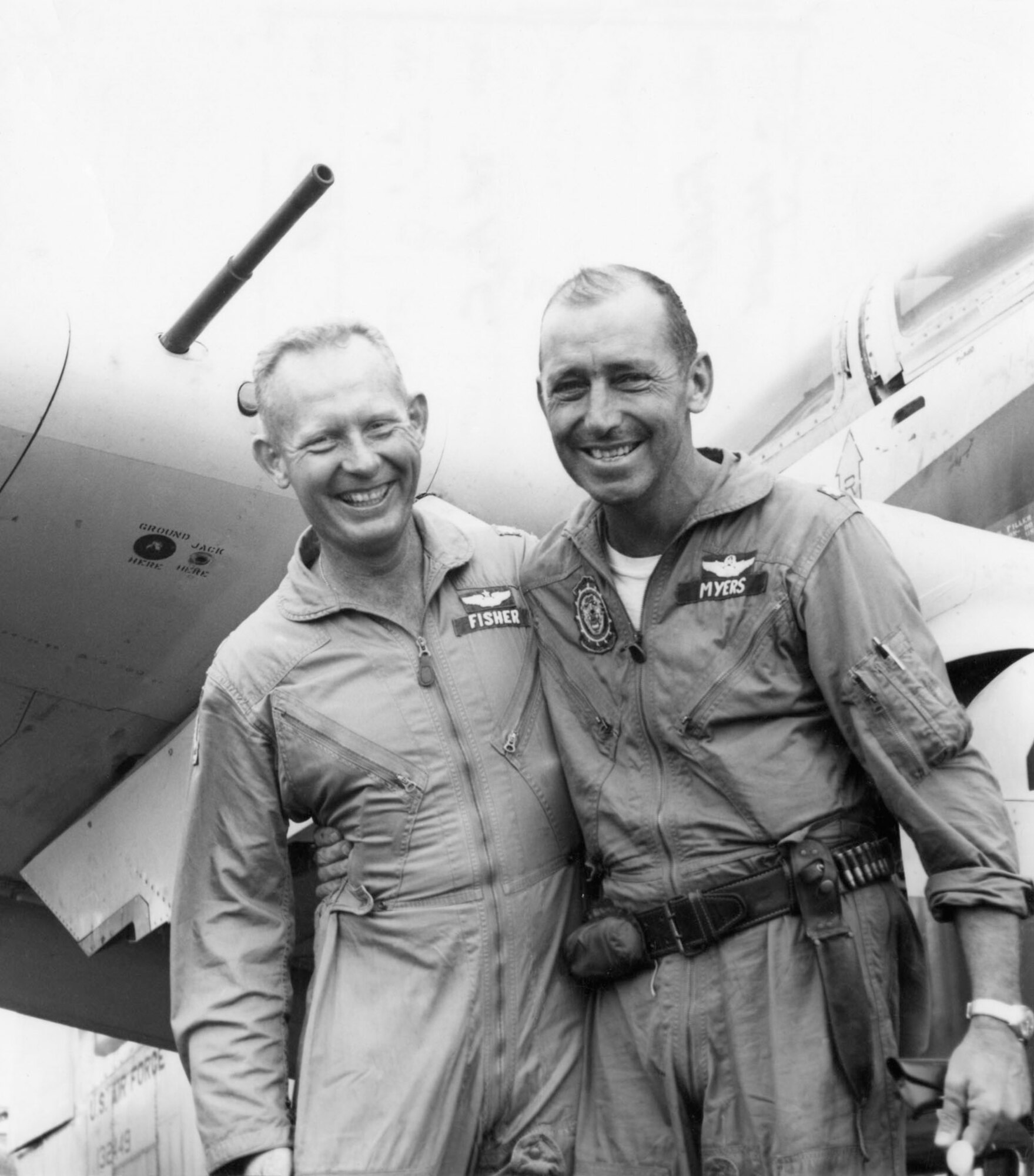 This photo of Maj. Bernard Fisher, left, and Maj. Wayne Myers, was taken in Vietnam, 1966. Fisher and Myers were among a group of pilots strafing enemy positions to protect a camp next to a route used by insurgents flooding into South Vietnam from Laos. Myers’ plane was shot down and he was forced to crash-land because he was flying too low to bail out. (U.S. Air Force photo)(Released)
