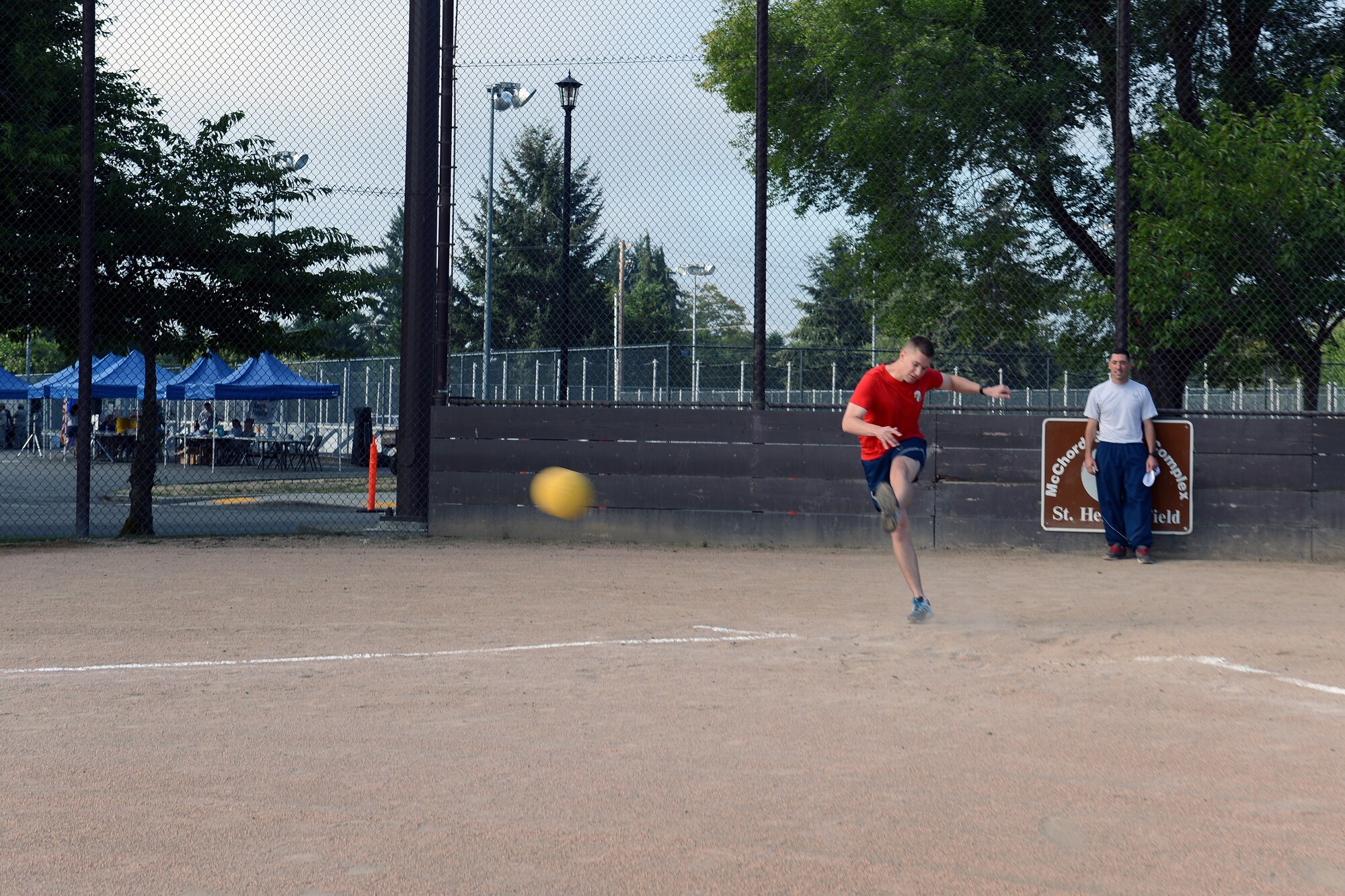 1st Lt. Michael Weber, 62nd Aerial Port Squadron passenger terminal flight commander, kicks a ball at a kickball game during Sports Day Aug. 22, 2014, at Joint Base Lewis-McChord, Wash. Team McChord held its annual Sports Day to boost morale and promote healthy living. (U.S. Air Force photo/Airman 1st Class Jacob Jimenez)