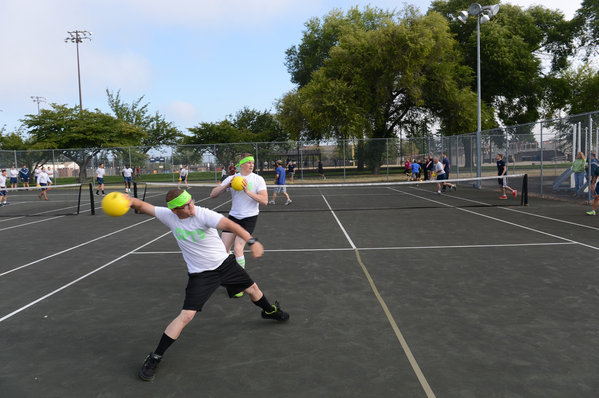 Airman 1st Class Dakota Travis (left), 62nd Comptroller Squadron financial services technician, and Airman 1st Class James Ratzlaff, 62nd CPTS financial services technician, throw dodge balls at another team during Sports Day Aug. 22, 2014, at Joint Base Lewis-McChord, Wash. For Sports Day Airmen were released from work to enjoy the day’s sports activities. (U.S. Air Force photo/Airman 1st Class Jacob Jimenez)  