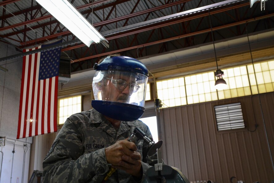 Technical Sergeant Harold Fulghum shapes and grinds a joggle block to be used on the simulated aircraft structure being built by the 507th Air Refueling Wing fabrication flight's sheet metal shop.  Fulghum came up with the idea to build the simulator.  It gives sheet metal workers the opportunity to work on the leading edge of a KC-135R Stratotanker wing without the jet actually being broken.  (U.S. Air Force photo/Senior Airman Mark Hybers)