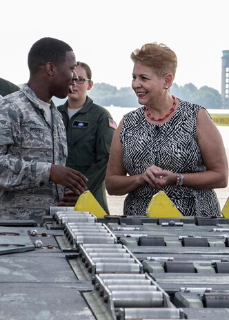 Airman 1st Class Kalem Postell, 437th Aerial Port Squadron air transportation specialist, speaks with the Honorable Jessica L. Garfola Wright, Under Secretary of Defense for Personnel and Readiness, about the process of loading heavy cargo on a C-17 Globemaster III aircraft at Joint Base Charleston, S.C. Aug. 22, 2014. Wright is the senior policy advisor to the secretary of defense on recruitment, career development, pay and benefits for 1.4 million Active-Duty military servicemembers, 1.1 million Guard and Reserve servicemembers, 740,000 Department of Defense civilians, and is responsible for overseeing the overall state of military readiness. (U.S. Air Force photo/Michael Dukes)