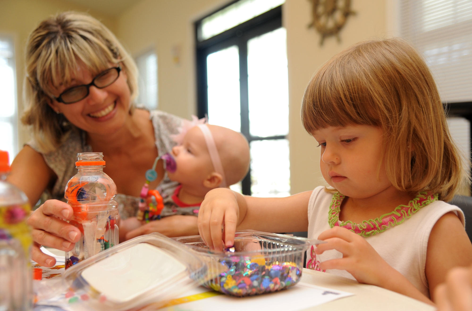 The family of 1st Lt. Scott Hiles, 81st Medical Operations Squadron, participate in an arts and crafts session hosted by Families OverComing Under Stress program Aug. 20, 2014, at the Forest City Community Center, Keesler Air Force Base, Miss. The FOCUS program provides resiliency training to service members and their families. The children also had the book, “Today I Feel Silly: and Other Moods That Make my Day” read to them during story time.  (U.S. Air Force photo by Kemberly Groue)