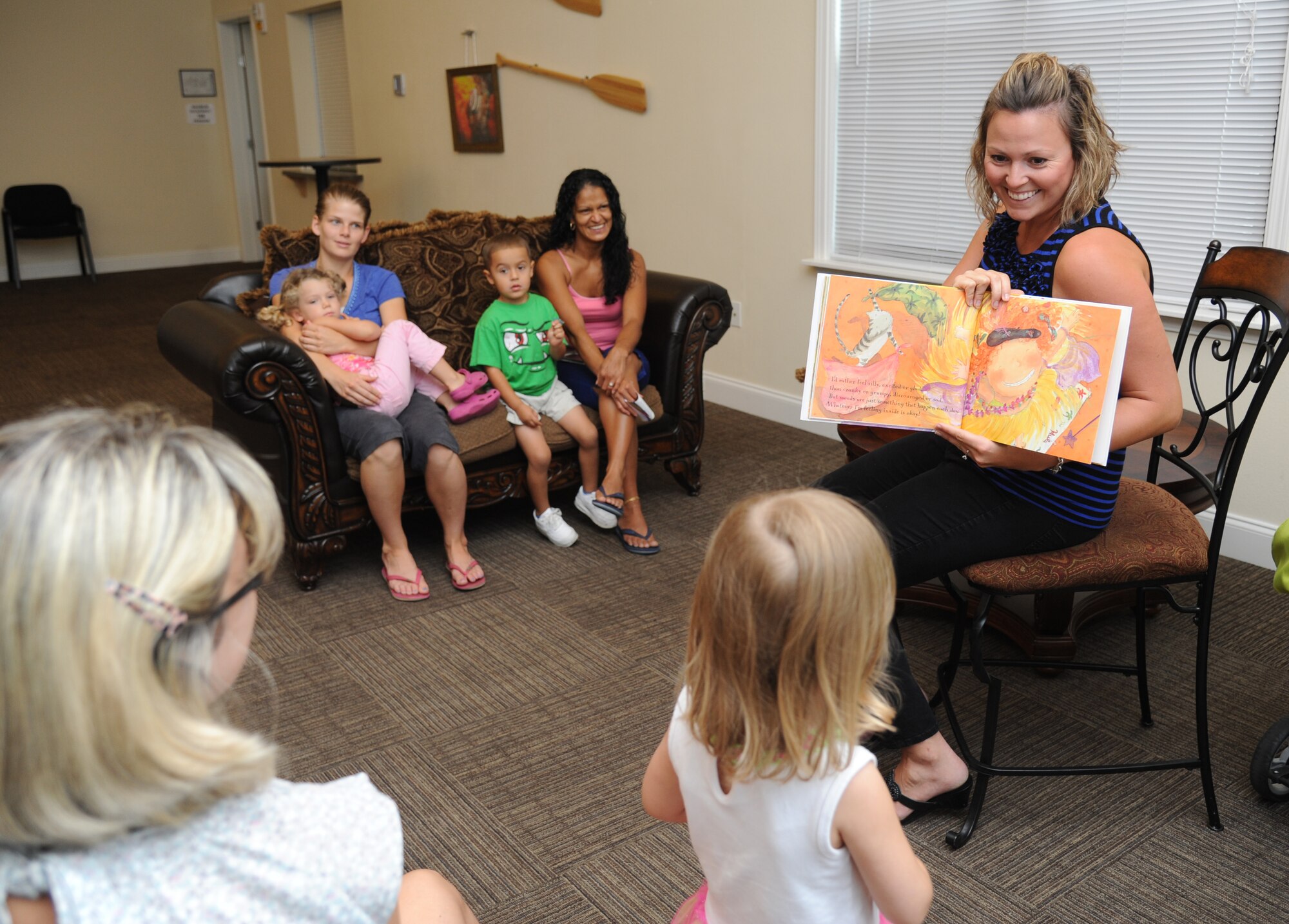 Kelly Wallace, Families OverComing Under Stress resiliency trainer, reads the book, “Today I Feel Silly: and Other Moods That Make my Day,” during FOCUS story time for preschoolers Aug. 20, 2014, at the Forest City Community Center, Keesler Air Force Base, Miss.  The FOCUS program provides resiliency training to service members and their families. The children also participated in an arts and crafts activity after the story time.  (U.S. Air Force photo by Kemberly Groue)
