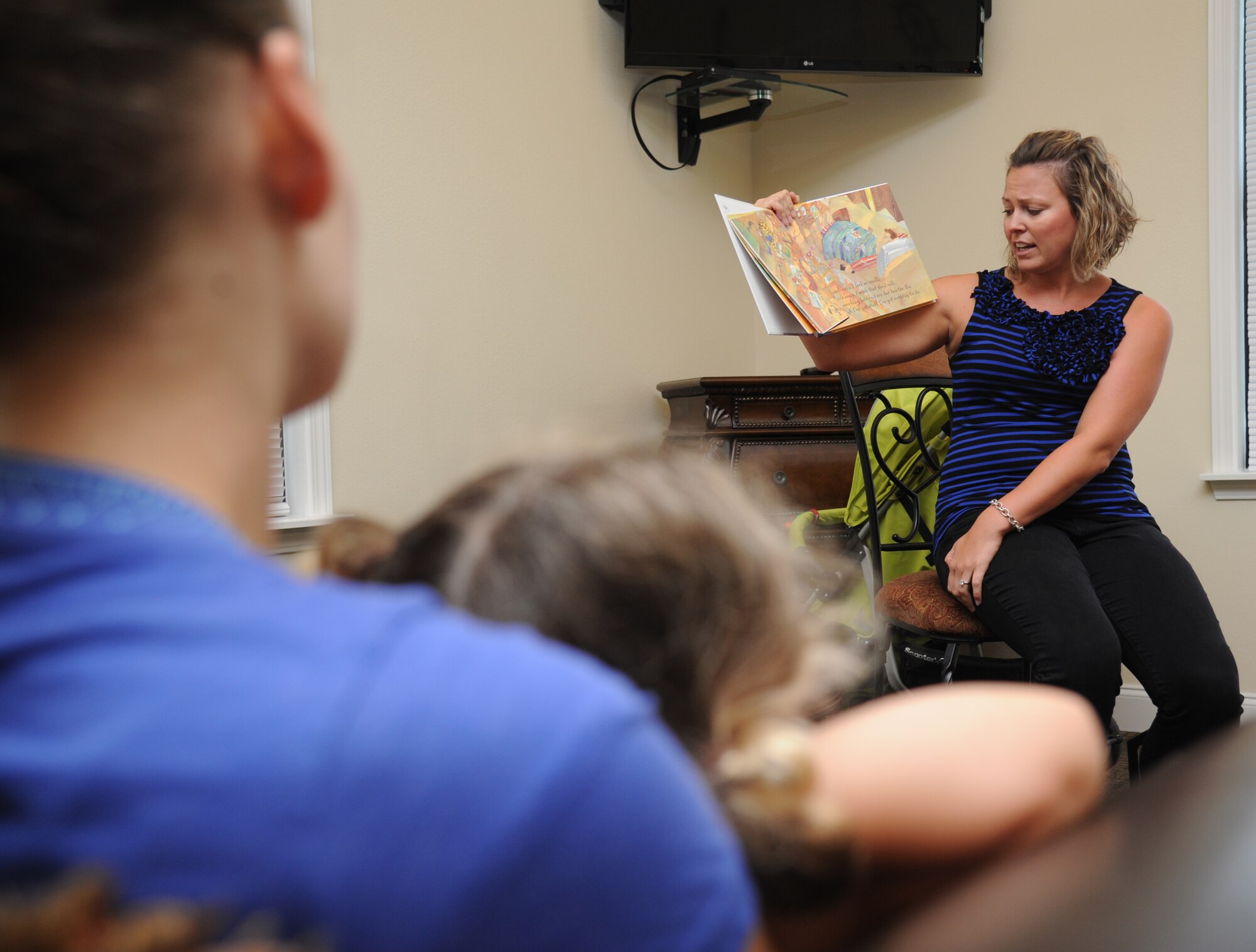 Kelly Wallace, Families OverComing Under Stress resiliency trainer, reads the book, “Today I Feel Silly: and Other Moods That Make my Day,” during FOCUS story time for preschoolers Aug. 20, 2014, at the Forest City Community Center, Keesler Air Force Base, Miss.  The FOCUS program provides resiliency training to service members and their families. The children also participated in an arts and crafts activity after the story time.  (U.S. Air Force photo by Kemberly Groue)