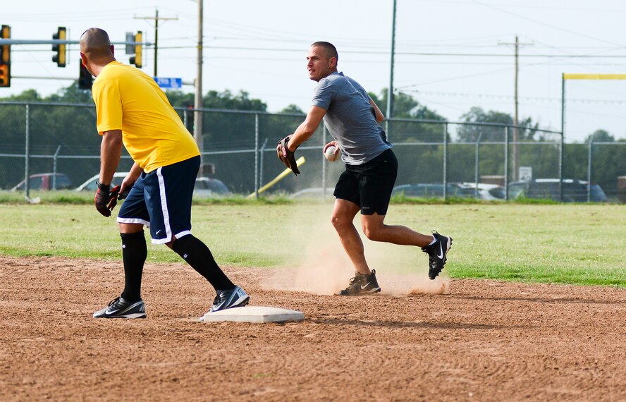 Okies’ Maj. Robert Akins fields a grounder and fires over to first base for the out during the double header between the 507th Okies and 513th Thumpers Thursday Aug. 14. The Thumpers took the twin bill with lopsided scores of 32 – 14 and 17 -3. This is the only meeting between the rivals this season as the Thumpers improve their perfect record to 6-0. (U.S. Air Force photo/Senior Airman Mark Hybers)