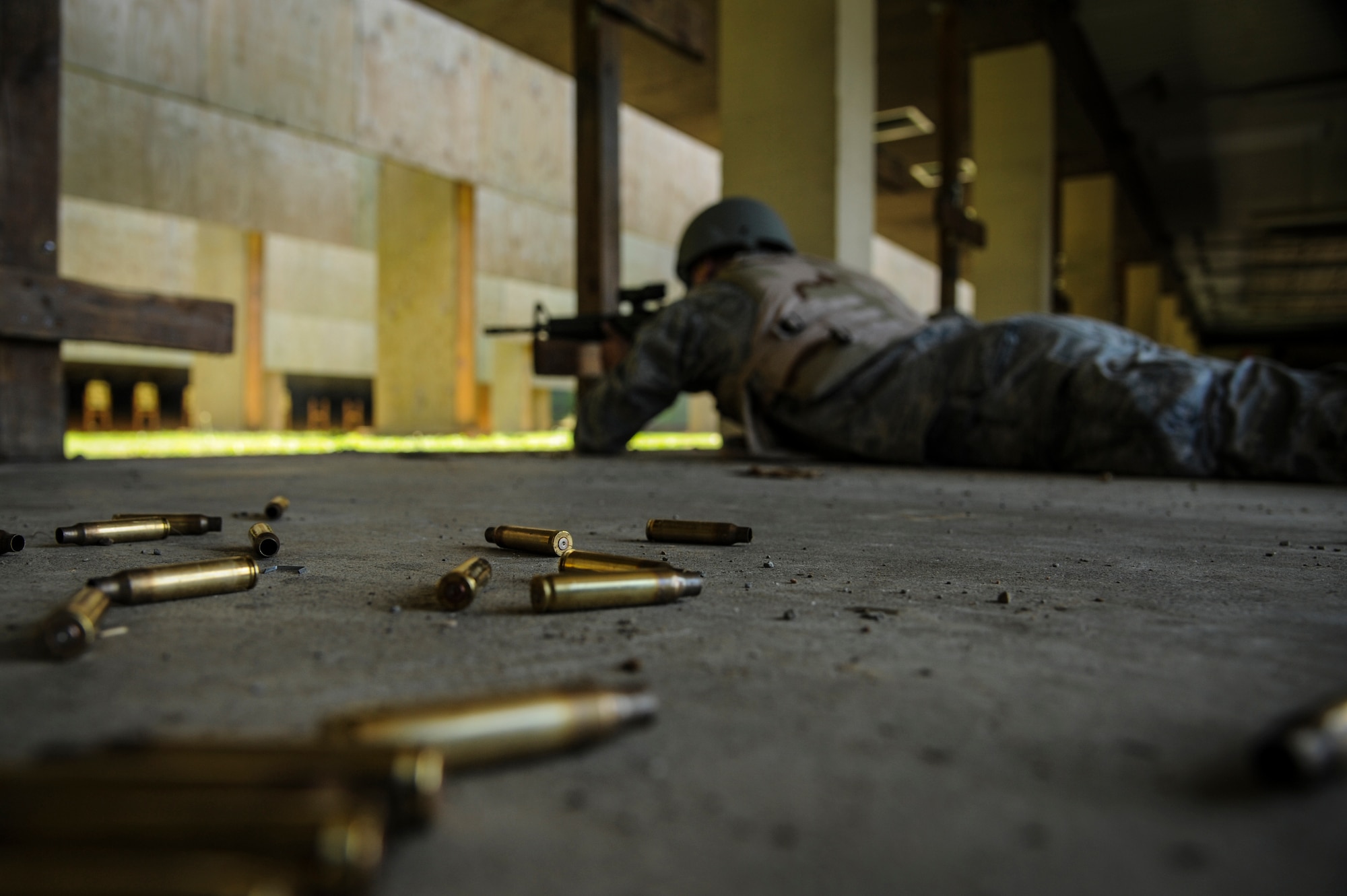 Airman 1st Class Christopher McEwen, a 19th Aircraft Maintenance Squadron crew chief, fires an M4 assault rifle as part of combat training Aug. 12, 2014, at Little Rock Air Force Base, Ark. All Airmen must be taught the proper use of combat arms and maintenance prior to deploying. (U.S. Air Force photo by Airman 1st Class Harry Brexel) 