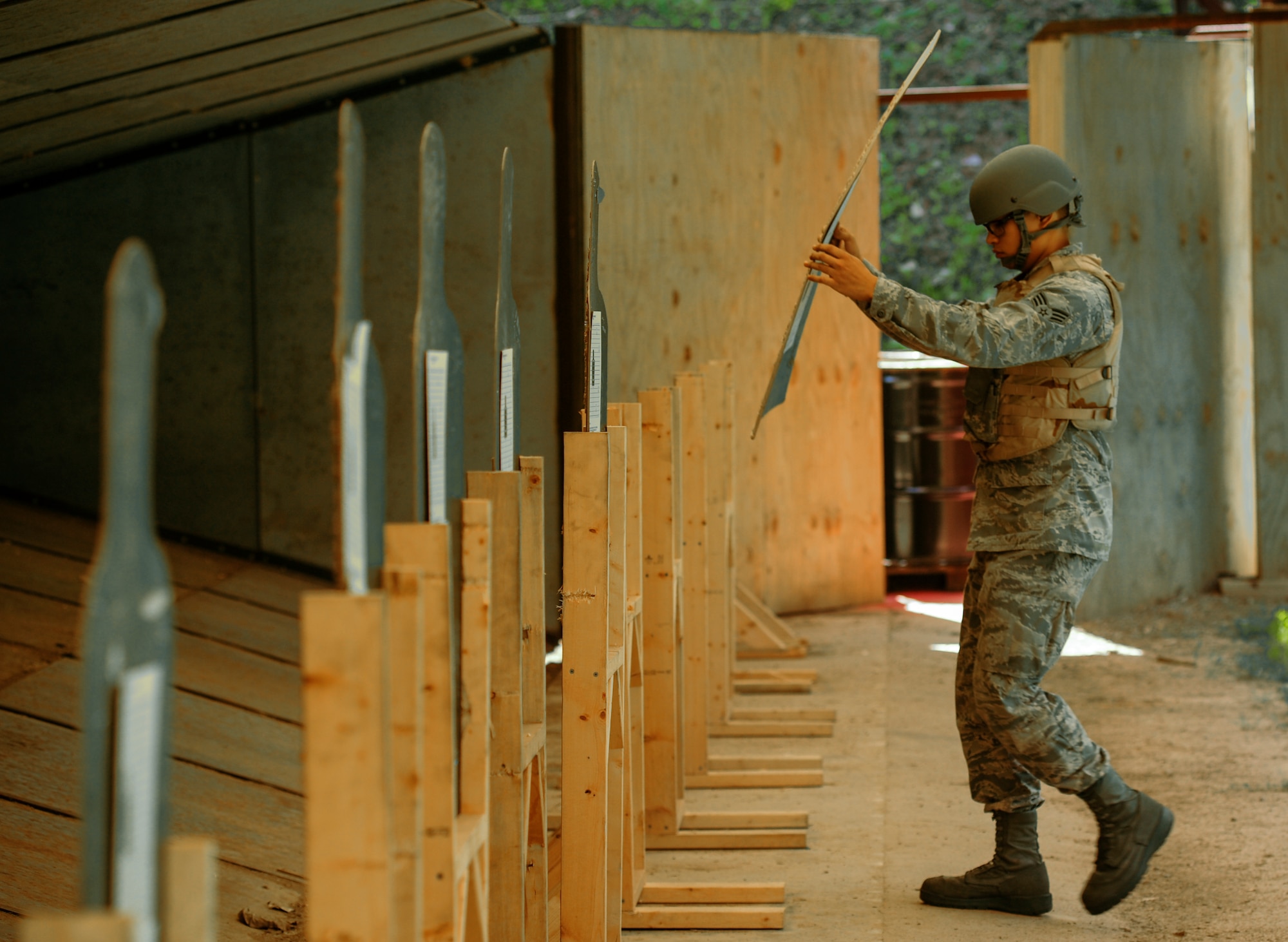 Senior Airman William Zelaya, a 19th Maintenance Squadron aerospace ground equipment journeyman,  places a target on a stand Aug. 12, 2014, at Little Rock Air Force Base, Ark. The 19th Security Forces Squadron Combat Arms Training and Maintenance flight teaches Airmen how to use a wide range of weapons each year. (U.S. Air Force photo by Airman 1st Class Harry Brexel)