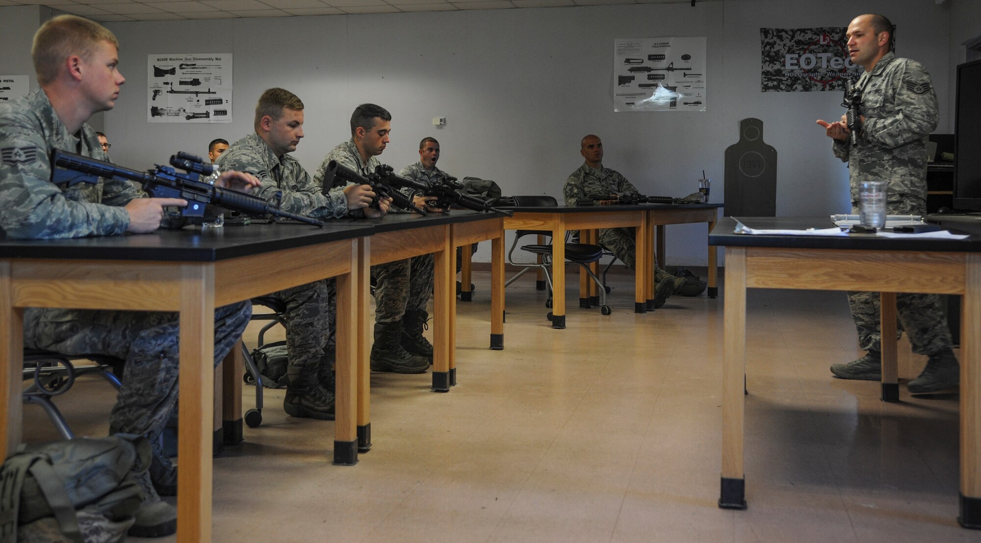 Staff Sgt. David Davis, a 19th Security Forces Squadron combat arms training and maintenance instructor, teaches a group of Airmen the proper use of an M4 assault rifle Aug. 12, 2014, at Little Rock Air Force Base, Ark. CATM classes are required prior to deploying or being stationed in a foreign environment. (U.S. Air Force photo by Airman 1st Class Harry Brexel) 