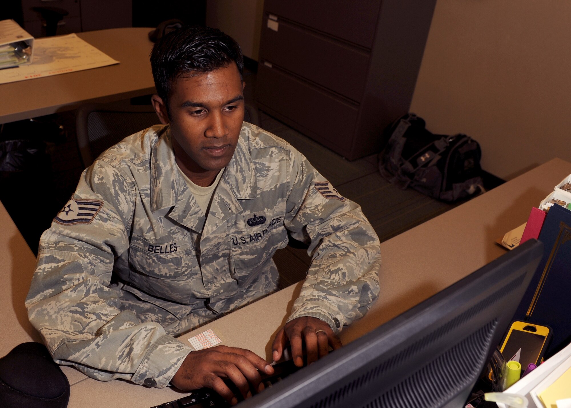 Staff Sgt. Bolin Belles, a 314th Maintenance Group computer support technician, produces trouble tickets for the enterprise service desk to support user accounts Aug. 18, 2014, at Little Rock Air Force Base, Ark. Belles is actively involved with the local community by volunteering for AFSA and organizing Habitat for Humanity projects. (U.S. Air Force photo by Airman 1st Class Scott Poe)