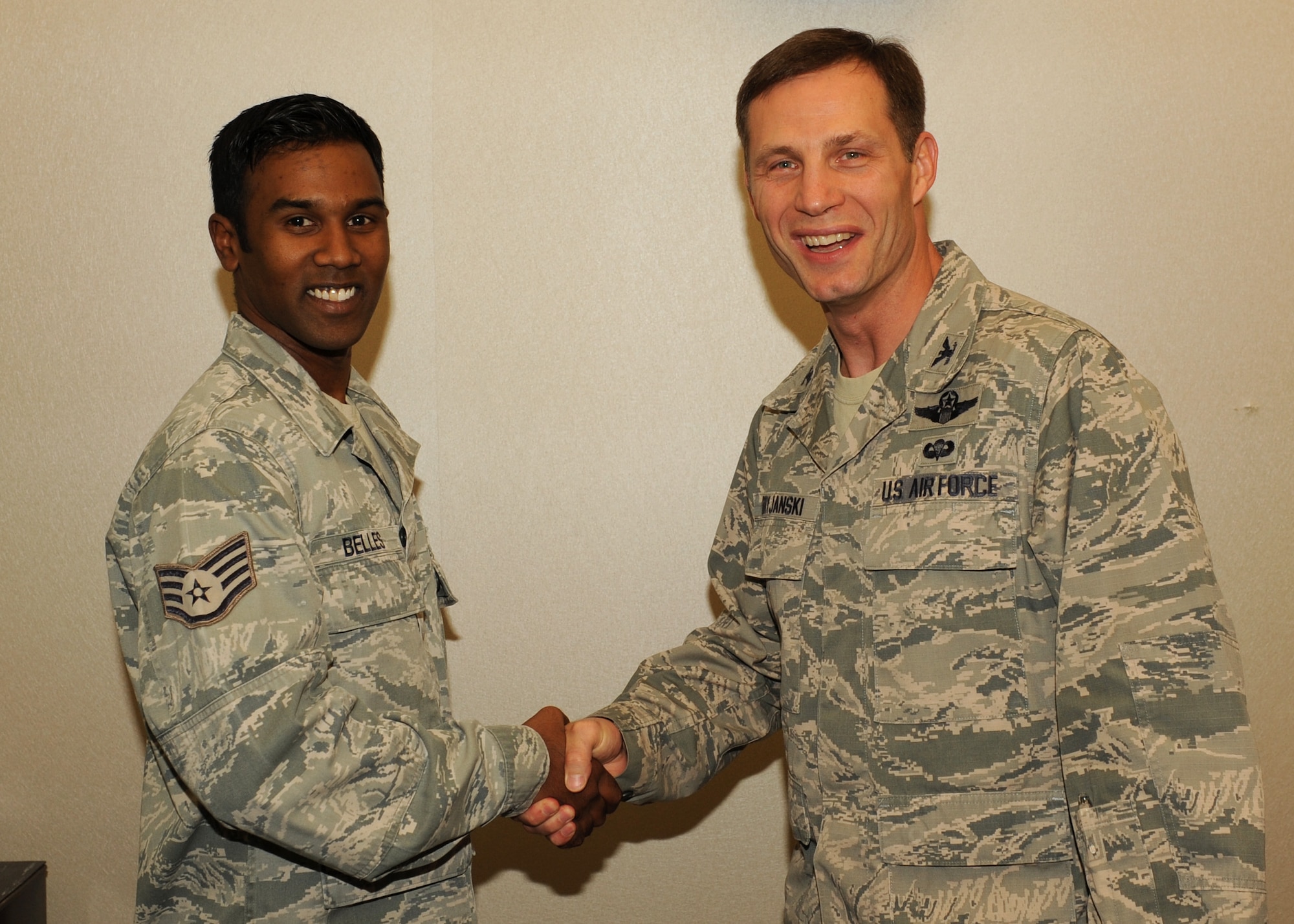 Col. James Dryjanski, the 314th Airlift Wing commander, congratulates Staff Sgt. Bolin Belles, a 314th Maintenance Group computer support technician, Aug. 18 at Little Rock Air Force Base, Ark. Belles a Needham, Mass., native, was recognized as the Combat Airlifter of the Week for managing the computer support training program for 670 maintainers throughout the 314th Maintenance Group and 314th Airlift Wing. (U.S. Air Force photo by Airman 1st Class Scott Poe)