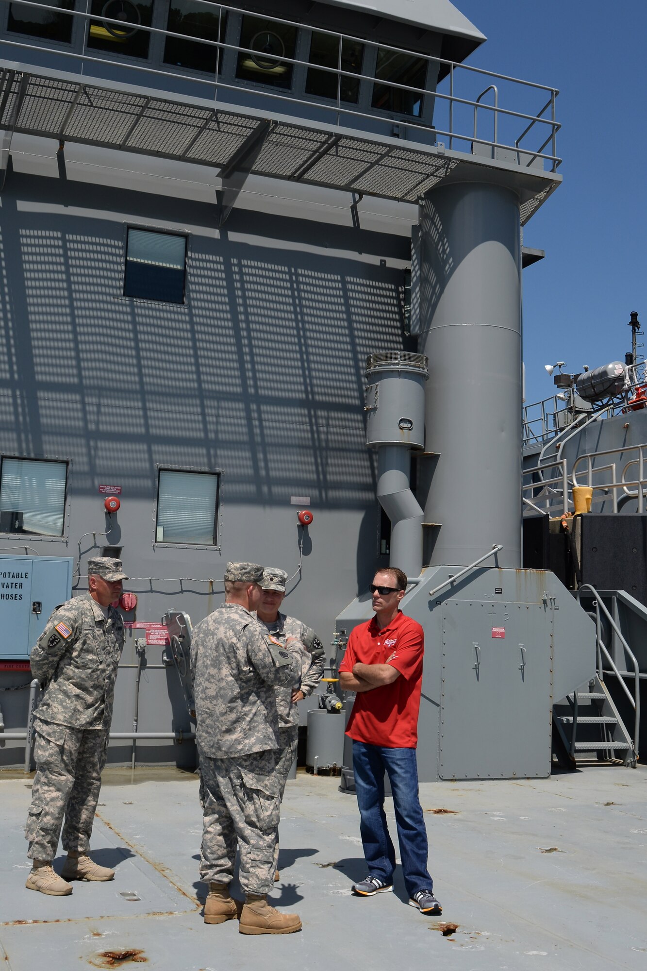 U.S. Army Lt. Col. Kimberly Nash, 10th Transportation Battalion, 7th Trans. Brigade (Expeditionary) commander, Chief Warrant Officer 2 Douglas Fuchs and Sgt. 1st Class Jonathon Plake, 97th Transportation Company, 10th Trans. Btn., 7th Trans. Bde. (Ex.), Landing Craft Utility 2001 U.S. Army Vessel Runnymede, vessel master and first mate, gave Kevin Harvick, NASCAR driver, a tour of the Runnymede during a visit to at Fort Eustis, Va., Aug. 20, 2014. During his visit, Harvick expressed appreciation for the Soldiers and gratitude for being able to learn about the different missions they are involved in. (U.S. Air Force photo by Staff Sgt. Teresa J.C. Aber/Released)