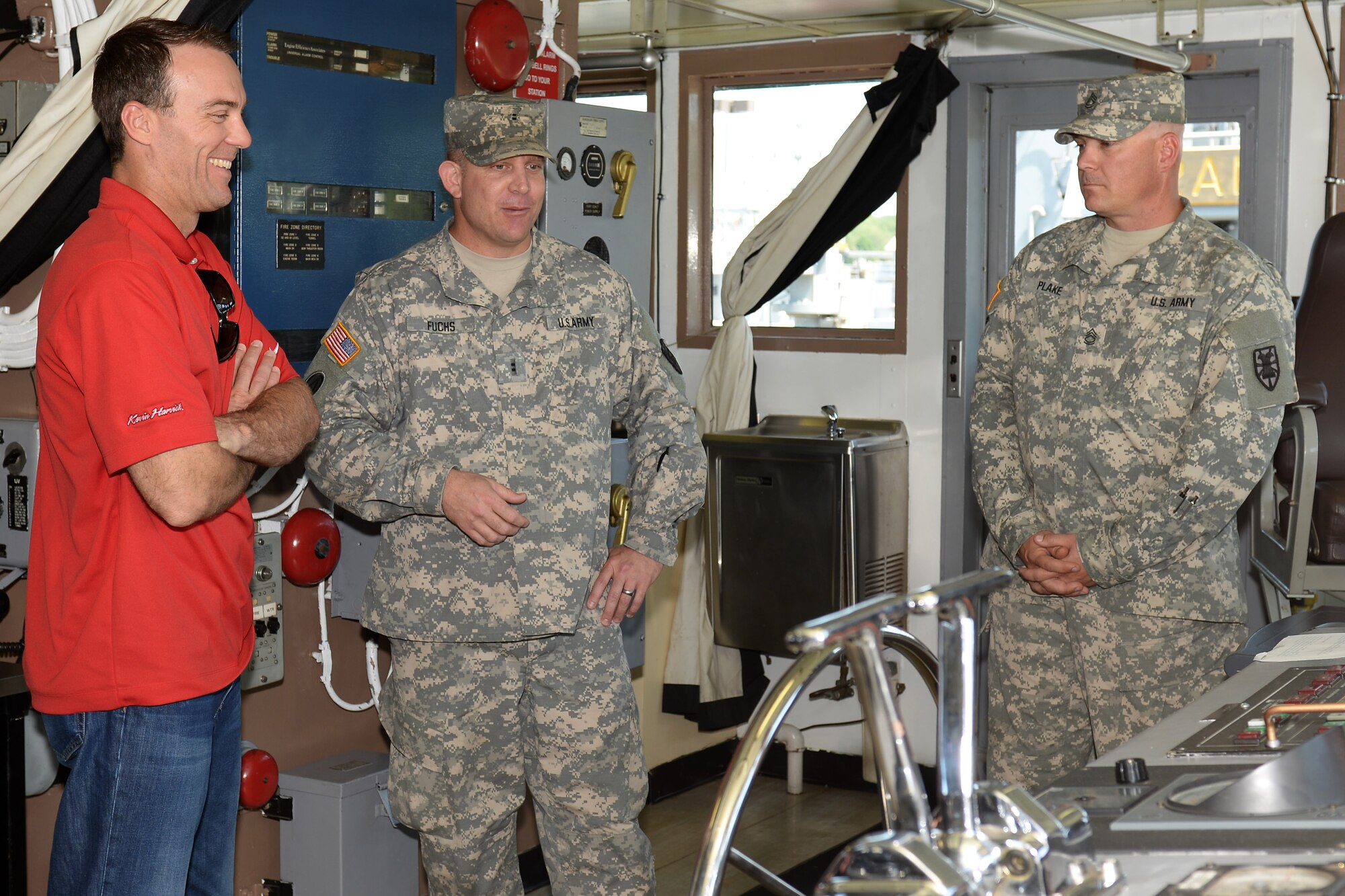 U.S. Army Chief Warrant Officer 2 Douglas Fuchs and Sgt. 1st Class Jonathon Plake, 97th Transportation Company, 10th Trans. Battalion, 7th Trans. Brigade (Expeditionary) U.S. Army Vessel Runnymede, Landing Craft Utility 2001 vessel master and first mate, brief Kevin Harvick, NASCAR driver, on the 7th Trans. Bde. (Ex.) mission during a tour of 3rd Port at Fort Eustis, Va., Aug. 20, 2014. After his tour, Harvick signed autographs and thanked Soldiers for their service. (U.S. Air Force photo by Staff Sgt. Teresa J.C. Aber/Released)