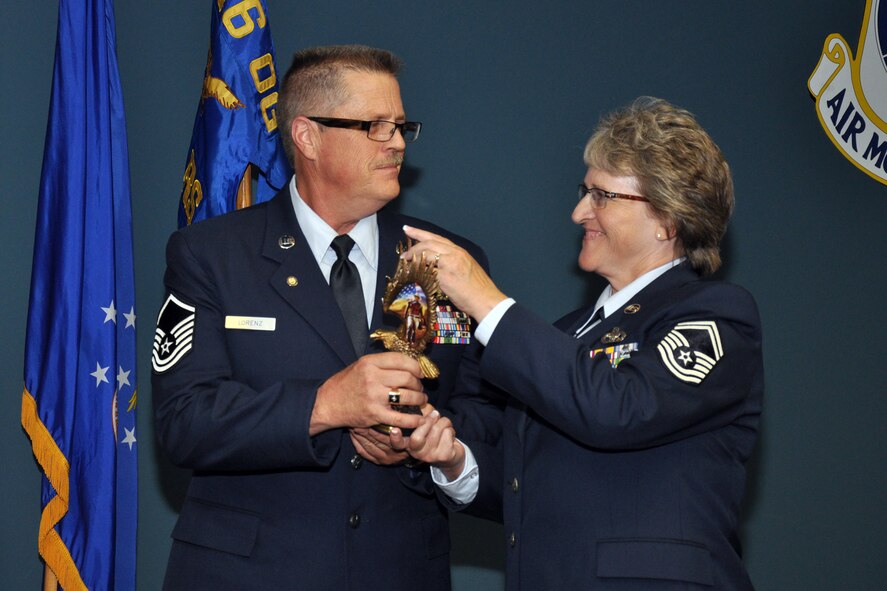 Senior Master Sgt. Donna Lorenz, 916th logistics plans superintendent, accepts an award with her husband, retired Master Sgt. Robert Lorenz during her retirement ceremony, Aug. 2014. (U.S. Air Force photo by Staff Sgt. Alan Abernethy) 