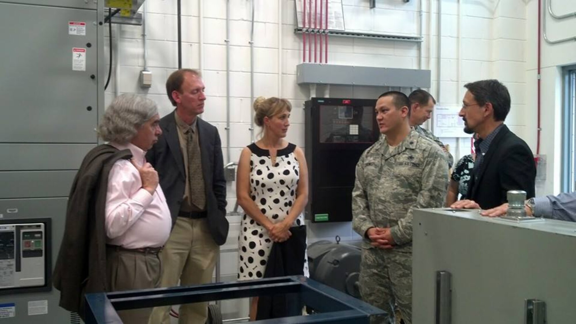 Lt. Col. Adrian Crowley (middle-right), Alaskan Command Deputy Director for logistics,  speaks with Secretary of Energy Dr. Ernest Moniz (left) during the 9th Annual Alaska Renewable Energy Fair and the Alaska Center for Energy and Power in Fairbanks, Alaska, Aug. 17. Members of ALCOM attended the site visit with Sen. Lisa Murkowski and Secretary of Energy Dr. Ernest Moniz to learn more about renewable energy research and needs in Alaska. (U.S. Air Force photo by Maj. Jennifer Lovett)