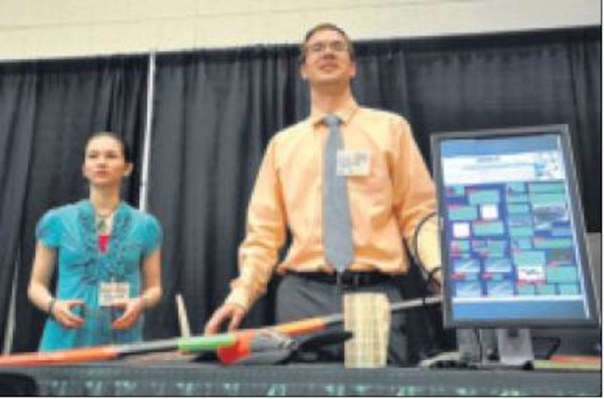 Summer-at-the-Edge students Shelly Gooden, bio-engineering major at Wright State University, and Mark Schreck, mechanical engineering major at Ohio State University, discuss their work and the challenge associated with their remotely piloted small aircraft project this summer at SATE's open house. (Air Force photo by Michele Eaton)