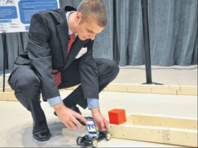 David Quante, Summer-at-the-Edge student and mechanical engineering major at Ohio State University, demonstrates his team's project, Cooperative Autonomous Sensing for Predictive Reconnaissance, at the Air Force Research Laboratory Discovery Lab's Summer-at-the-Edge open house Aug. 14, at Wright State University. (Air Force photo by Michele Eaton)