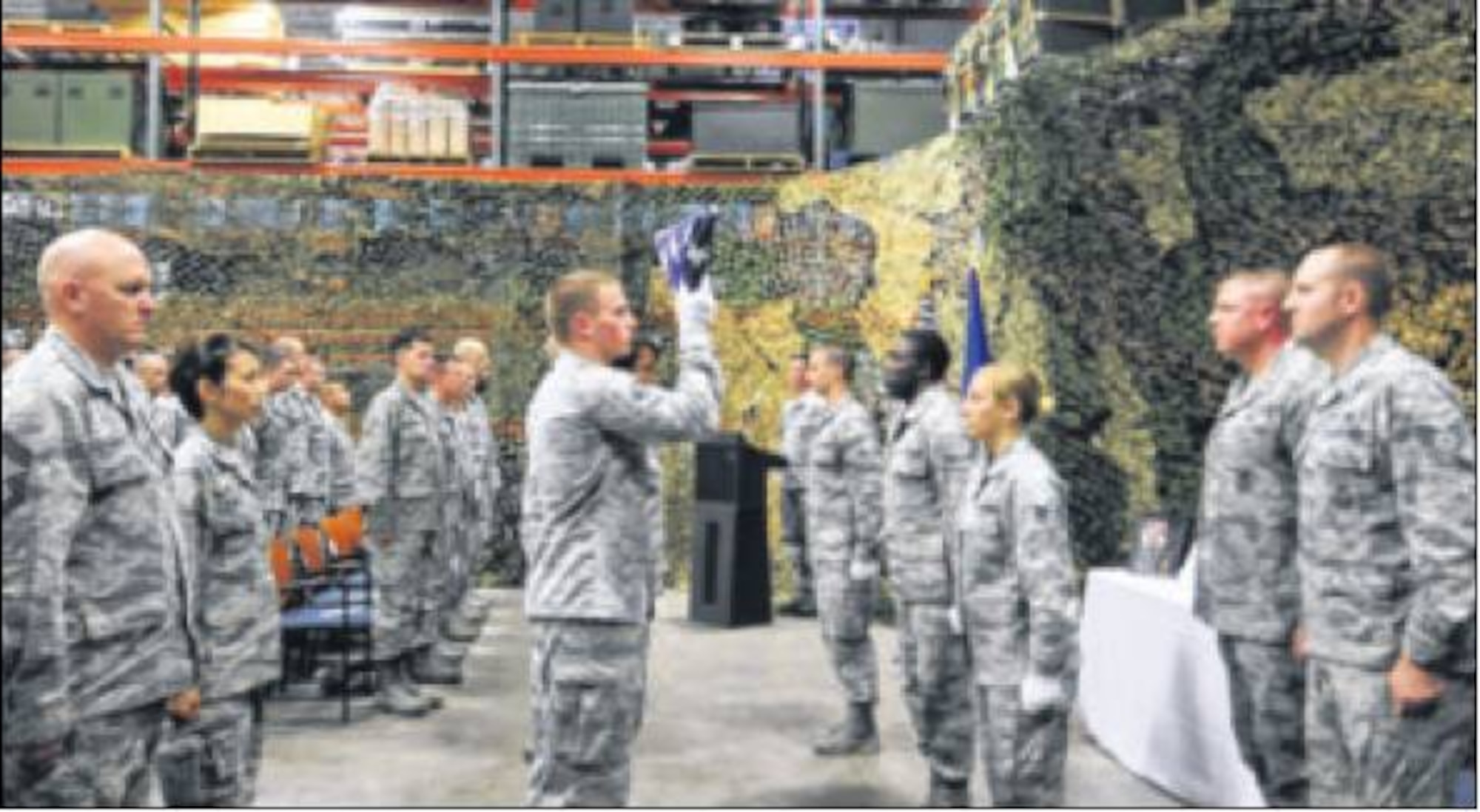 The 88th Security Forces Squadron military working dog memorial ceremony included readings, a flag-folding ceremony, the playing of "Taps" and a missing dog display of an empty crtae, leash and photos of Luja. (Air Force photo by Diane Kofoed)