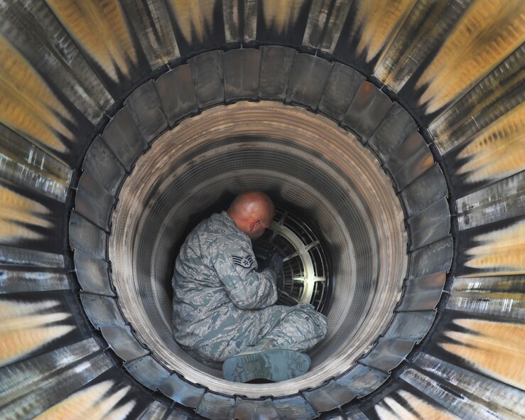 U.S. Air Force Staff Sgt. Michael Woronec, a crew chief with the 180th Fighter Wing, inspects the exhaust of an F-16 Fighting Falcon on the flight line of the Alpena Combat Readiness Training Center in Alpena, Michigan, Aug. 21, 2014. The 180th Fighter Wing deployed to the CRTC to participate Operation Northern Strike, a joint exercise led by the National Guard that demonstrates the combined power of the air and ground forces. (Air National Guard photo by Staff Sgt. Amber Williams/Released)