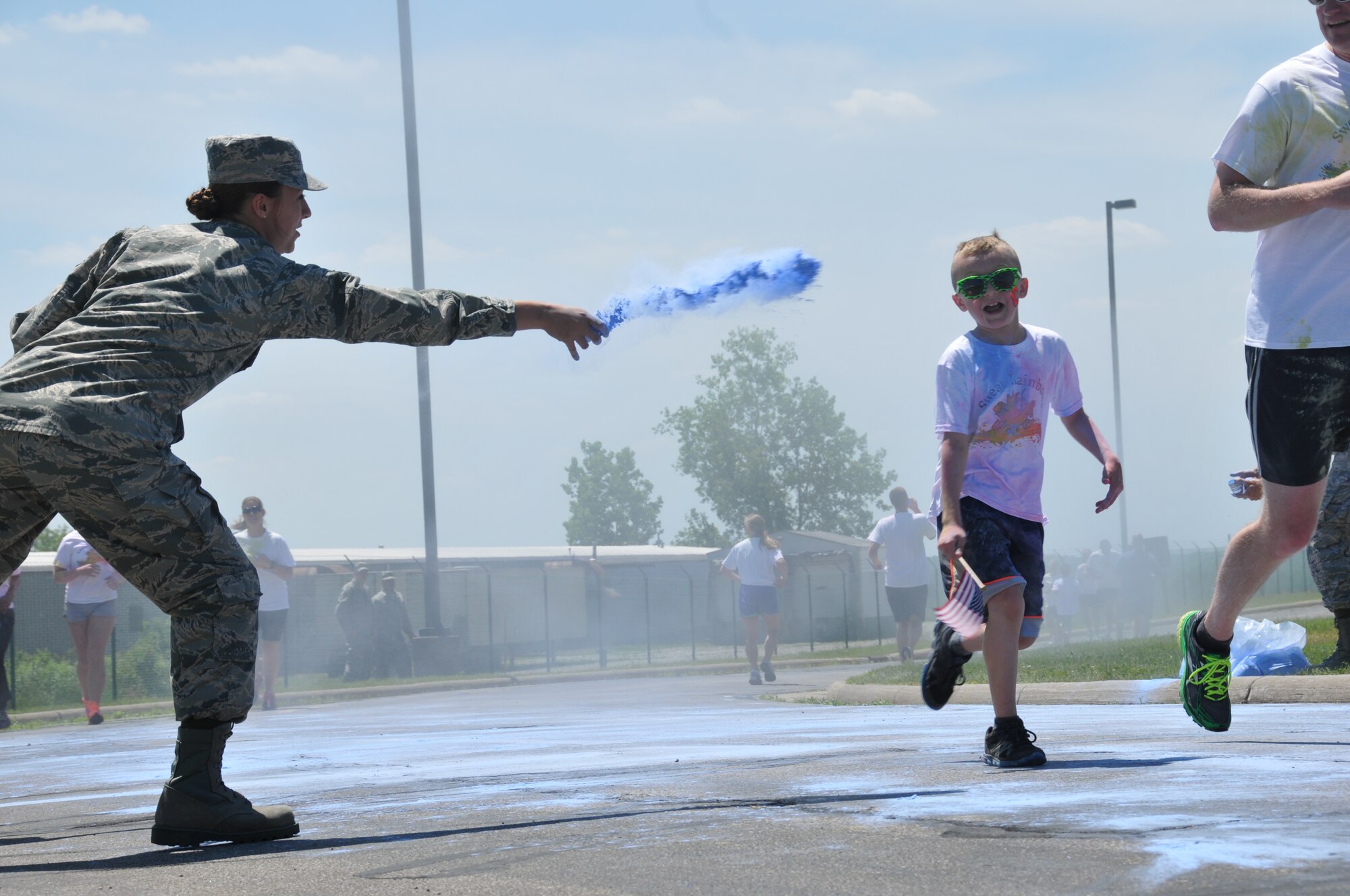 179th Airlift Wing members and their family members run through clouds of colored corn starch during the Color Fun 5k at the 179th Airlift Wing, Mansfield, OH, June 7, 2014. (U.S. Air National Guard Photo by TSgt Joseph Harwood \Released)