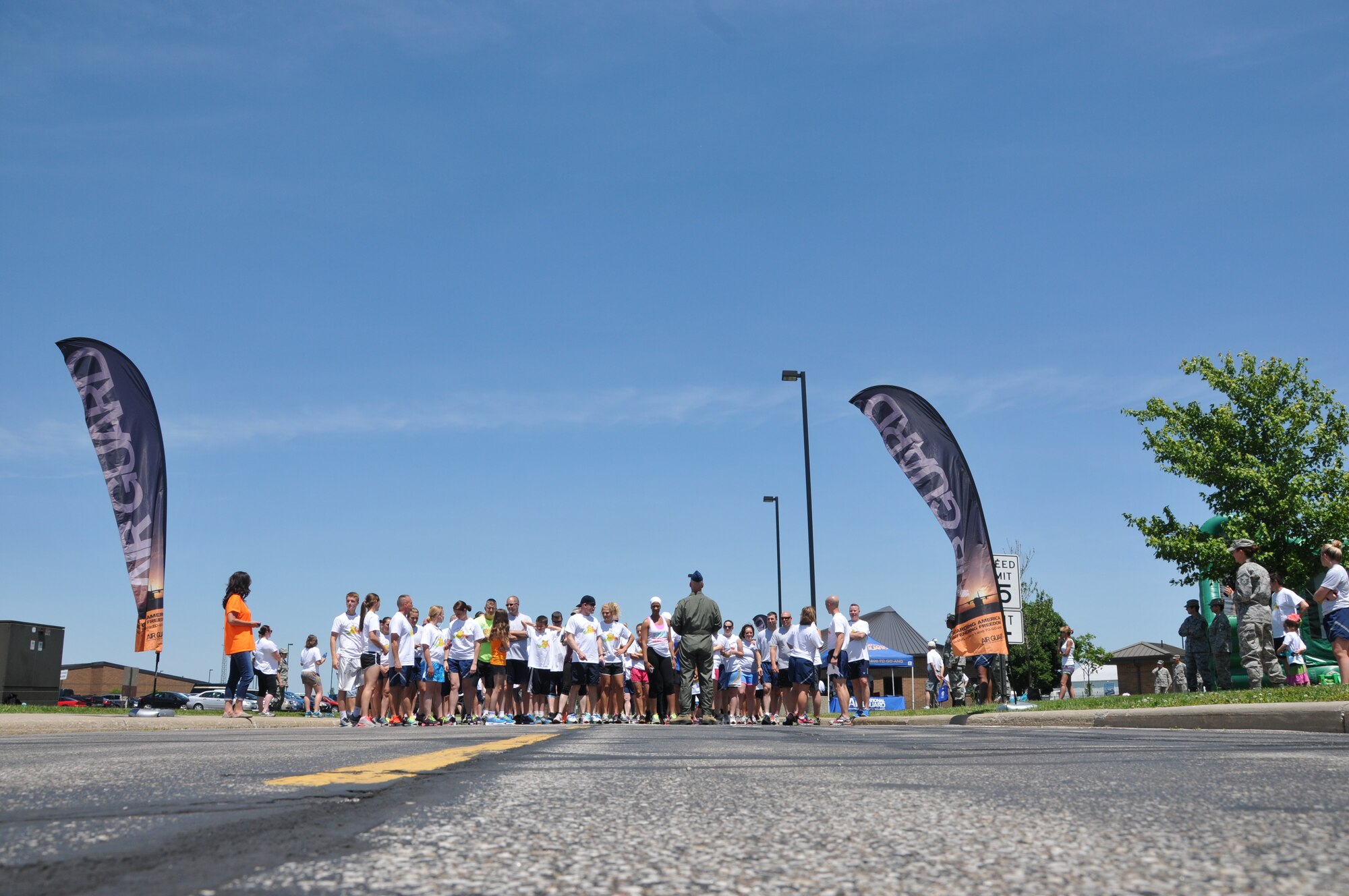 179th Airlift Wing members and their family members run through clouds of colored corn starch during the Color Fun 5k at the 179th Airlift Wing, Mansfield, OH, June 7, 2014. (U.S. Air National Guard Photo by TSgt Joseph Harwood \Released)