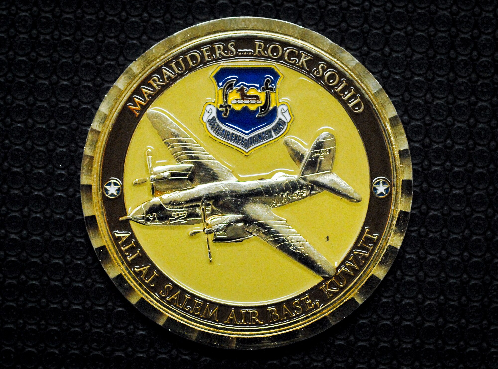 The 386th Air Expeditionary Wing’s recently redesigned commander’s coin displays past and present elements of the wing’s history.  Dr. Chuck Merkel, 53rd Wing historian, assisted the 386th AEW staff in updating the coin while serving a six-month Southwest Asia deployment to the wing.  The 386th AEW recently recognized Merkel for his efforts by presenting him with the new coin. (U.S. Air Force photo/Kevin Gaddie)  