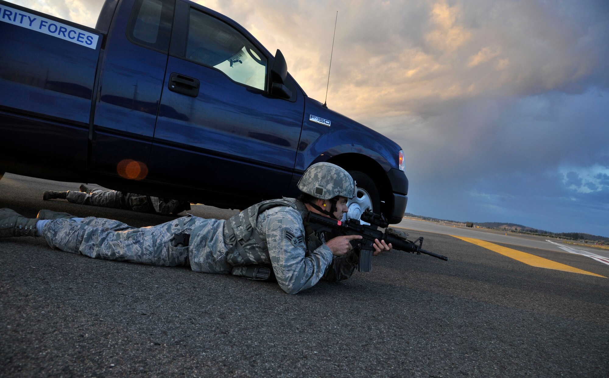 A 92nd Security Forces Squadron Airman protects the flight line ensuring safe and secure mission accomplishment during an operational readiness exercise at Fairchild Air Force Base, Washington, Aug. 22, 2014. Training exercises are planned and executed regularly to maintain mission readiness, to ensure the base’s preparedness for various potential emergency scenarios, and to evaluate the base’s ability to accomplish the mission. (U.S. Air Force photo by Senior Airman Mary O’Dell/Released)