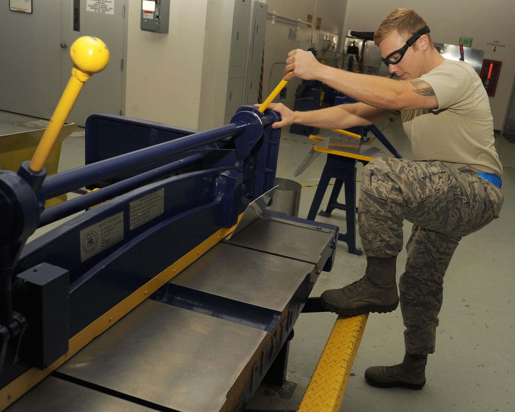 Staff Sgt. Casey Durham uses a foot shear to trim excess material from an extrusion for final shaping at Fairchild Air Force Base, Washington, Aug. 20, 2014. Part of Durham’s day-to-day work is accomplishing a full inspection of the tanker for preventative maintenance, evaluate damage and corrosion on the aircraft and paint and place decals. Durham is an aircraft structural craftsman from the 92nd Maintenance Squadron. (U.S. Air Force photo by Staff Sgt. Samantha Krolikowski/Released)