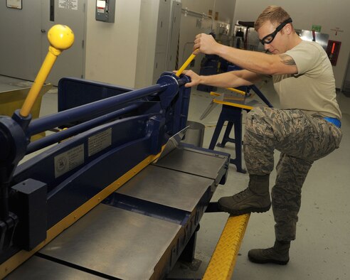 Staff Sgt. Casey Durham uses a foot shear to trim excess material from an extrusion for final shaping at Fairchild Air Force Base, Washington, Aug. 20, 2014. Part of Durham’s day-to-day work is accomplishing a full inspection of the tanker for preventative maintenance, evaluate damage and corrosion on the aircraft and paint and place decals. Durham is an aircraft structural craftsman from the 92nd Maintenance Squadron. (U.S. Air Force photo/Staff Sgt. Samantha Krolikowski)