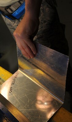 Staff Sgt. Casey Durham uses a cornace break to fabricate an extrusion at Fairchild Air Force Base, Washington, Aug. 20, 2014. The cornace break bends the metal to 90 degrees to increase structural integrity of the piece. Durham is an aircraft structural craftsman from the 92nd Maintenance Squadron. (U.S. Air Force photo/Staff Sgt. Samantha Krolikowski)