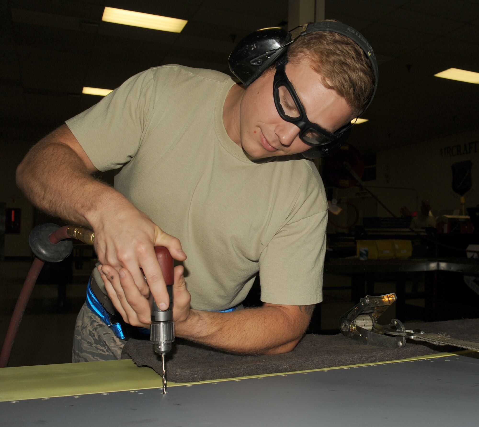 Staff Sgt. Casey Durham replaces the trailing edge of a flap from the KC-135 Stratotanker at Fairchild Air Force Base, Washington, Aug. 20, 2014. When the flaps are damaged or need replaced, a new trailing edge is drilled and installed for pivot installation. As an aircraft structural craftsman, Durham evaluates damage and corrosion of the tanker and repairs it. Durham is an aircraft structural craftsman from the 92nd Maintenance Squadron. (U.S. Air Force photo by Staff Sgt. Samantha Krolikowski/Released)
