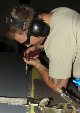 Staff Sgt. Casey Durham replaces the trailing edge of a flap from the KC-135 Stratotanker at Fairchild Air Force Base, Washington, Aug. 20, 2014. When the flaps are damaged or need replaced, a new trailing edge will be drilled and installed for pivot installation. Durham is an aircraft structural craftsman from the 92nd Maintenance Squadron. (U.S. Air Force photo/Staff Sgt. Samantha Krolikowski)