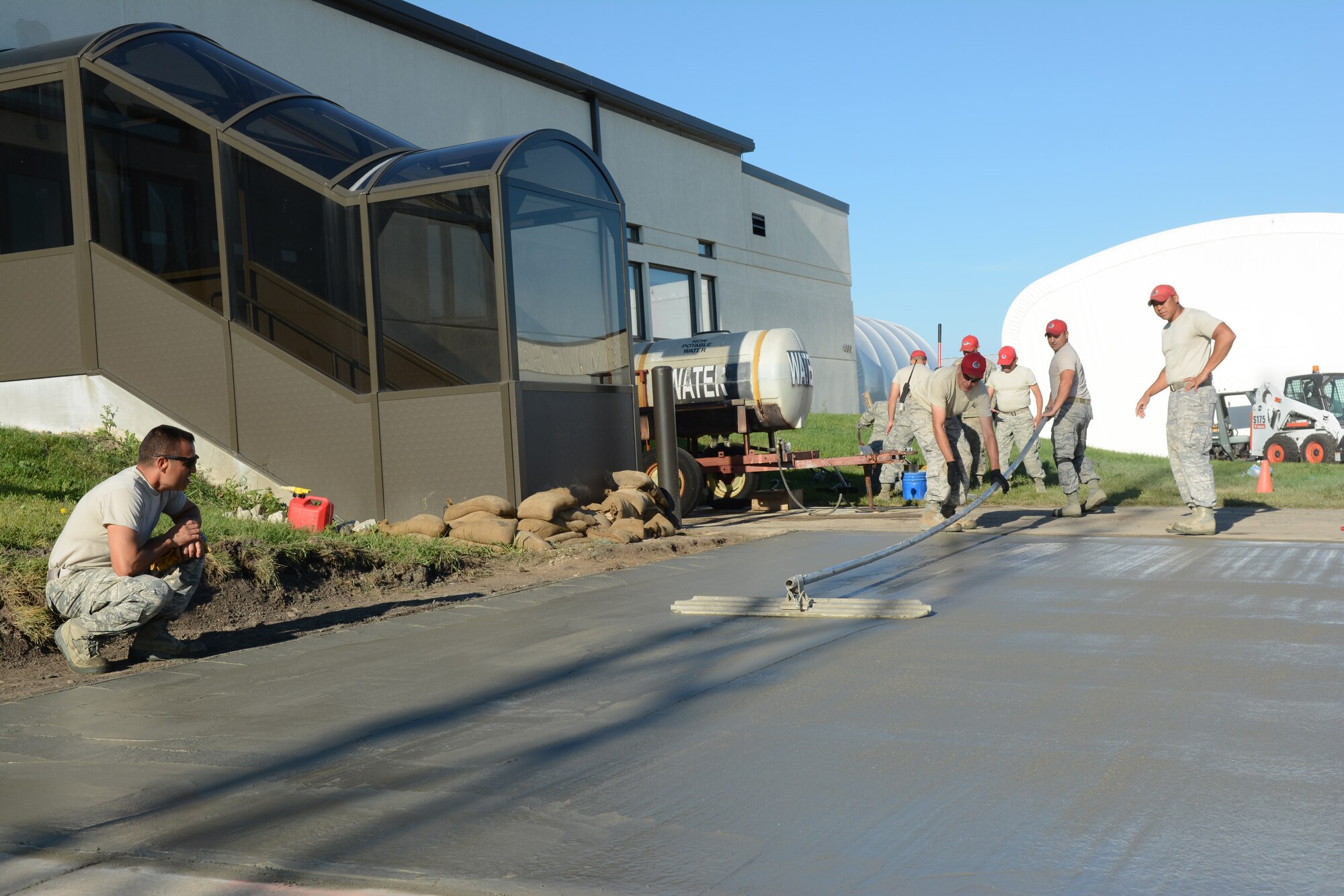 Airmen from the 210th Red Horse Squadron out of Kirtland Air Force Base, New Mexico, finish a concrete project at the 115th Fighter Wing in Madison, Wis., Aug. 14, 2014. The group temporarily deployed to the 115 FW to complete various infrastructure projects on the base, while gaining real-world experience. (Air National Guard photo by Senior Airman Andrea F. Liechti)