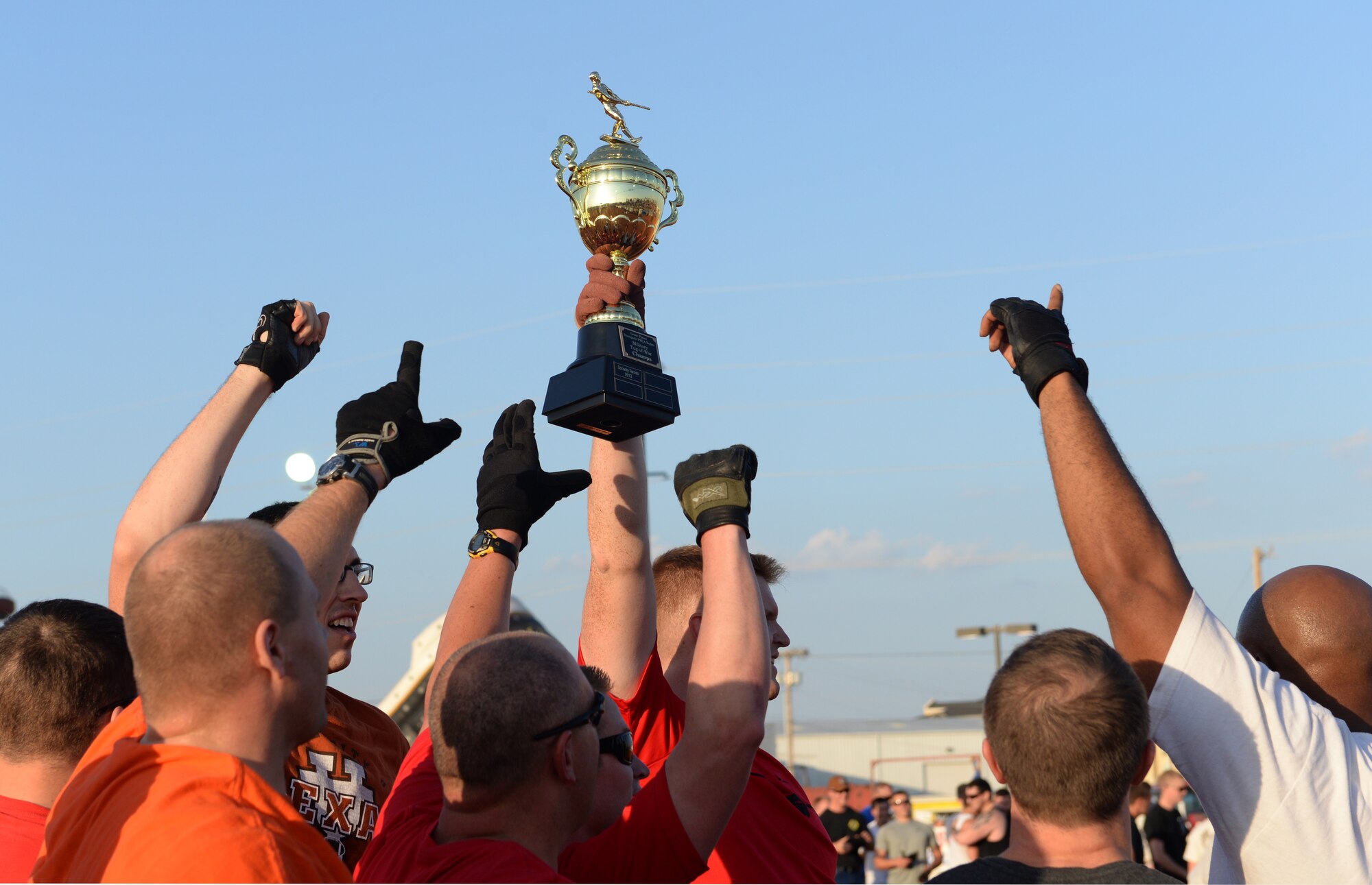 ALTUS, Okla. – Members of the Operations Group Tug-of-War team celebrates their victory over the 97th Security Forces Squadron during the Tug-of-War competition at the 36th Annual Great Plains Stampede Rodeo, Aug. 21, 2014. Security Forces tried to defend their title, but the Operations Group proved the stronger team. (U.S. Air Force photo by Airman 1st Class Nathan Clark/Released)