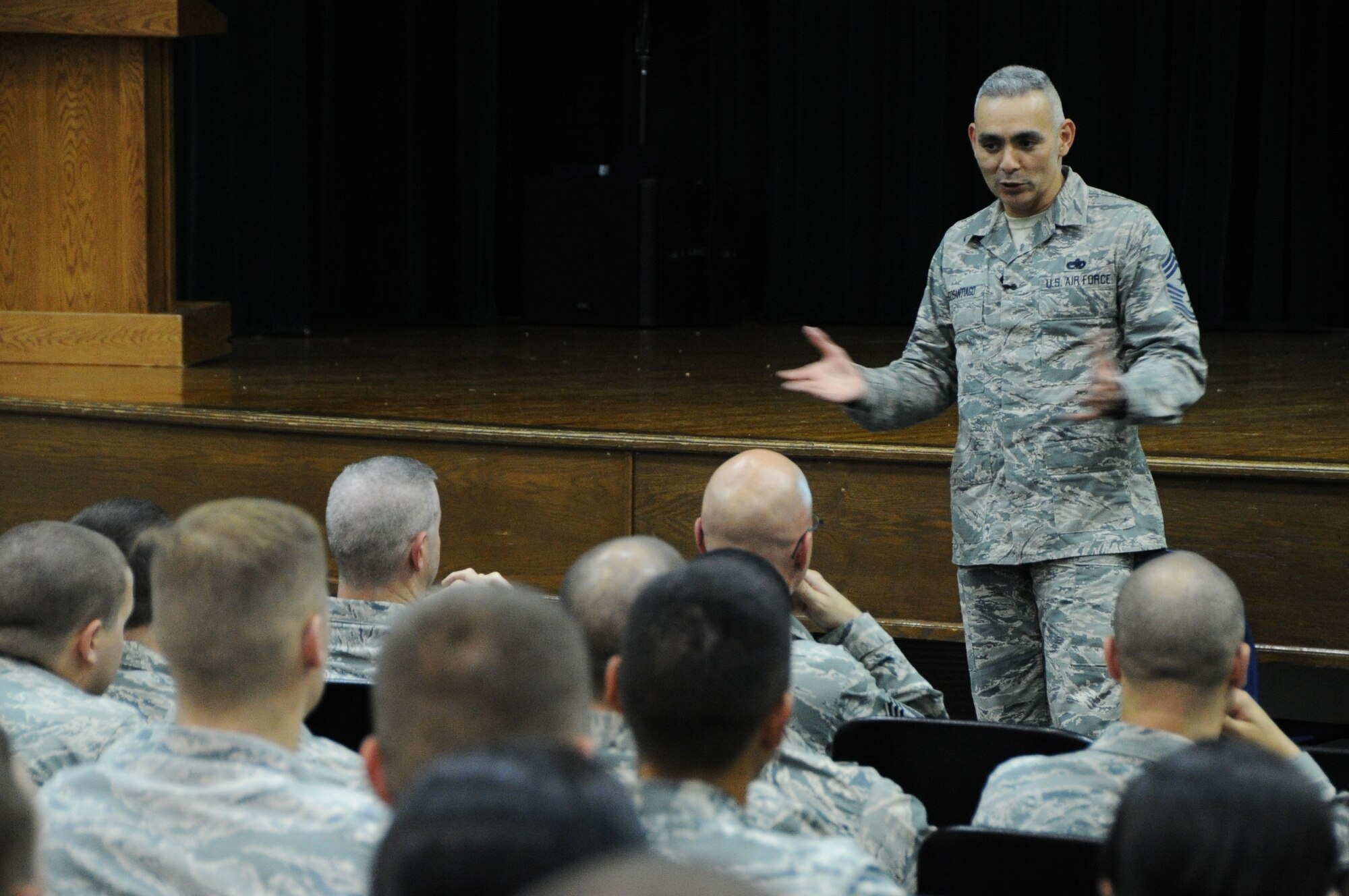 Chief Master Sgt. Jose LugoSantiago, Air Force District of Washington command chief, addresses Airmen at the base theater during an enlisted call on Joint Base Andrews, Maryland, Aug. 20, 2014. LugoSantiago covered issues regarding topics such as new enlisted evaluation report, career vectoring and force management. (U.S. Air Force photo/Staff Sgt. Matt Davis)