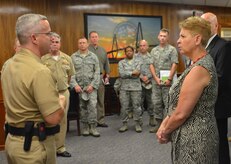 Cmdr. Patrick Boyce, Naval Consolidated Brig Charleston commanding officer, gives a security brief to Under Secretary of Defense for Personnel and Readiness, Jessica L. Garfola Wright, Aug. 22, 2014, at the NCBC on Joint Base Charleston, S.C. Wright was on a two-day tour of JB Charleston to observe the active-duty and Reserve missions. The mission of Naval Consolidated Brig Charleston is to ensure the security, good order, discipline and safety of adjudged and pretrial prisoners; to retrain and restore the maximum number of personnel to honorable service; to prepare prisoners for return to civilian life as productive citizens; and when directed by superior authority, detain enemy combatants in accordance with guidance from the President via the Secretary of Defense. (U.S. Air Force photo/Eric Sesit)