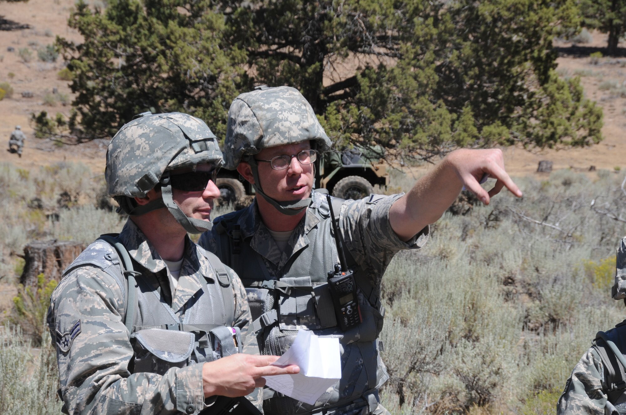 U.S. Air Force Master Sgt. Michael Moore directs Airman 1st Class Garrett Leanders, both of 270th Air Traffic Control Squadron,  on how to form up a perimeter during an area defense exercise July 24, near Bonanza, Oregon. The 270th ATCS controls the airspace for Kingsley Field but also has an expeditionary tasking; this year’s annual training emphasized that capability and involved several exercises off base. (U.S. Air National Guard photo by Tech. Sgt. Jefferson Thompson/Released)