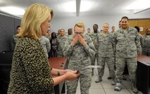 Secretary of the Air Force Deborah Lee James presents Airman 1st Class Siri Lerum, 461st Air Control Wing, with a signed photo of the Airman and her family with James at Lerum’s basic training graduation ceremony. During her tour of Robins Air Force Base, James visited the 78th Air Base Wing, Air Force Reserve Command, the 461st and 116th Air Control wings and the Warner Robins Air Logistics Complex. (U.S. Air Force photo by Tommie Horton) 