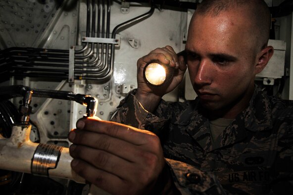U.S. Air Force Staff Sgt. Clayton Walton, 509th Aircraft Maintenance Squadron crew chief, inspects a mainlock gear actuator at Whiteman Air Force Base, Missouri, Aug. 15, 2014. The 509th AMXS weapons load crew are preparing for the 2014 Global Strike Challenge. The challenge is a combination of historic bomb and missile competitions and incorporates three major events into one: the former Proud Shield bomber competition, the former Olympic Arena missile competition, and the former Giant Sword combat weapons loading competition. (U.S. Air Force photo by Airman 1st Class Keenan Berry/Released)