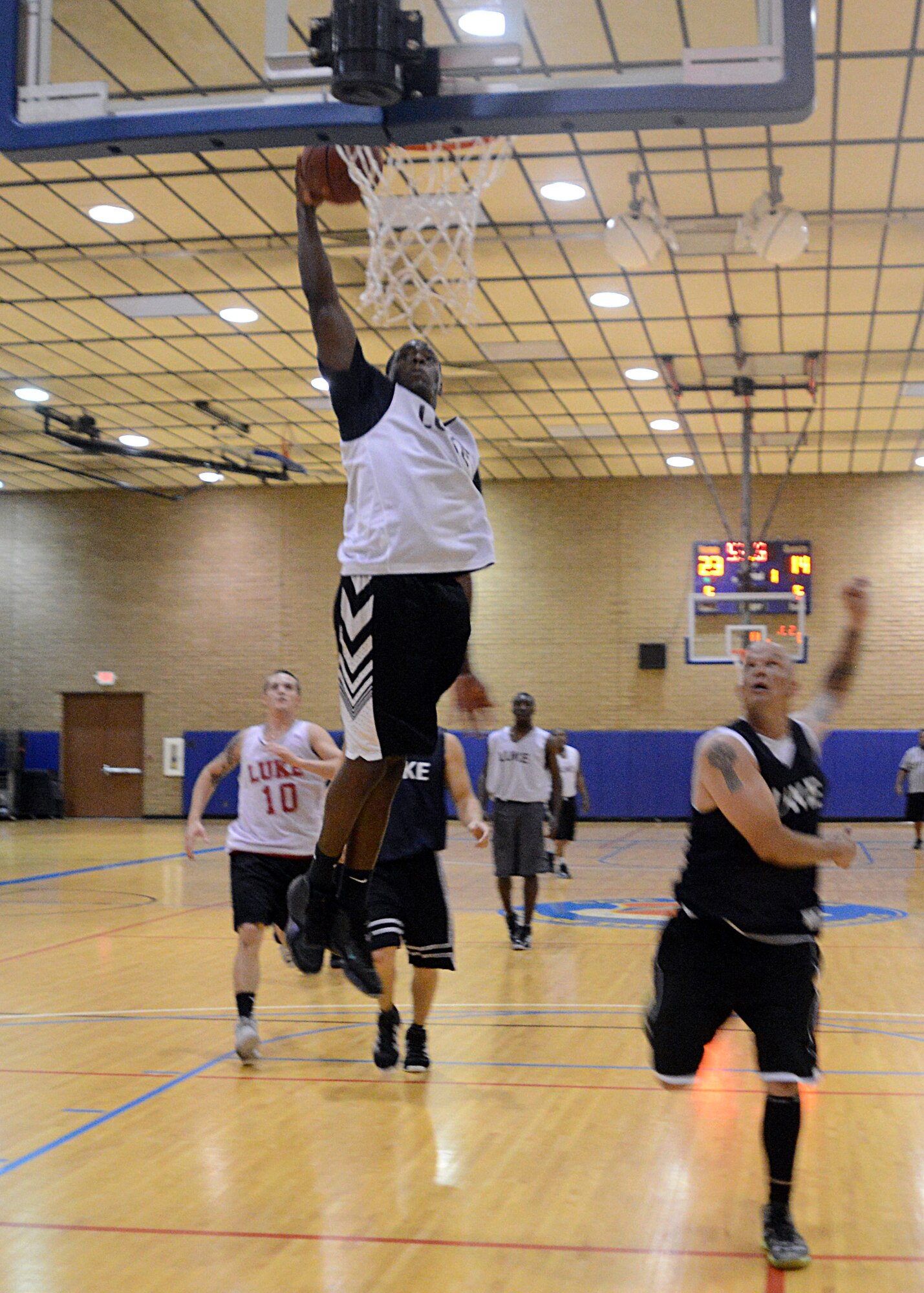 Kyle Smith, 56th Medical Operations Squadron, scores Aug. 11 during the intramural basketball championship game against 56th Civil Engineer Squadron at Luke Air Force Base. MDG defeated CE 53-36. (U.S. Air Force photo/Senior Airman Grace Lee)