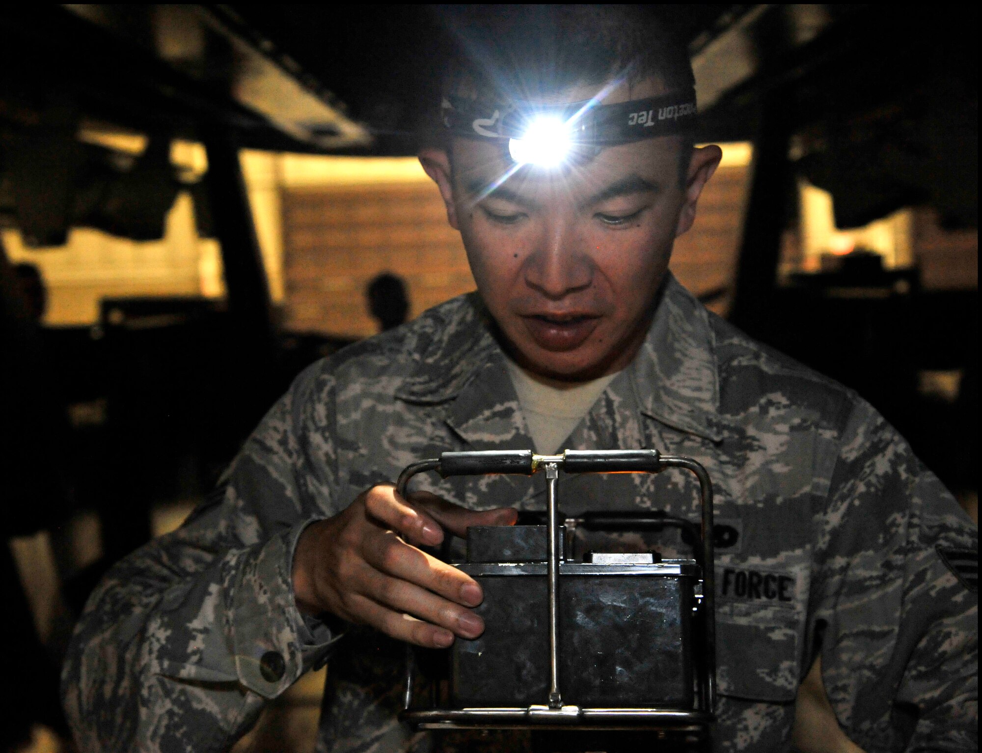 U.S. Air Force Senior Airman SiuYu Leung, 509th Aircraft Maintenance Squadron weapons load member, operates a portable control unit during a Global Strike Challenge practice Aug. 11, 2014 at Whiteman Air Force Base, Missouri. The Global Strike Challenge provides maintainers from across the command the opportunity to participate in innovative thinking, teamwork and esprit de corps that are central to the AFGSC’s mission. (U.S. Air Force photo by Airman 1st Class Keenan Berry/Released)