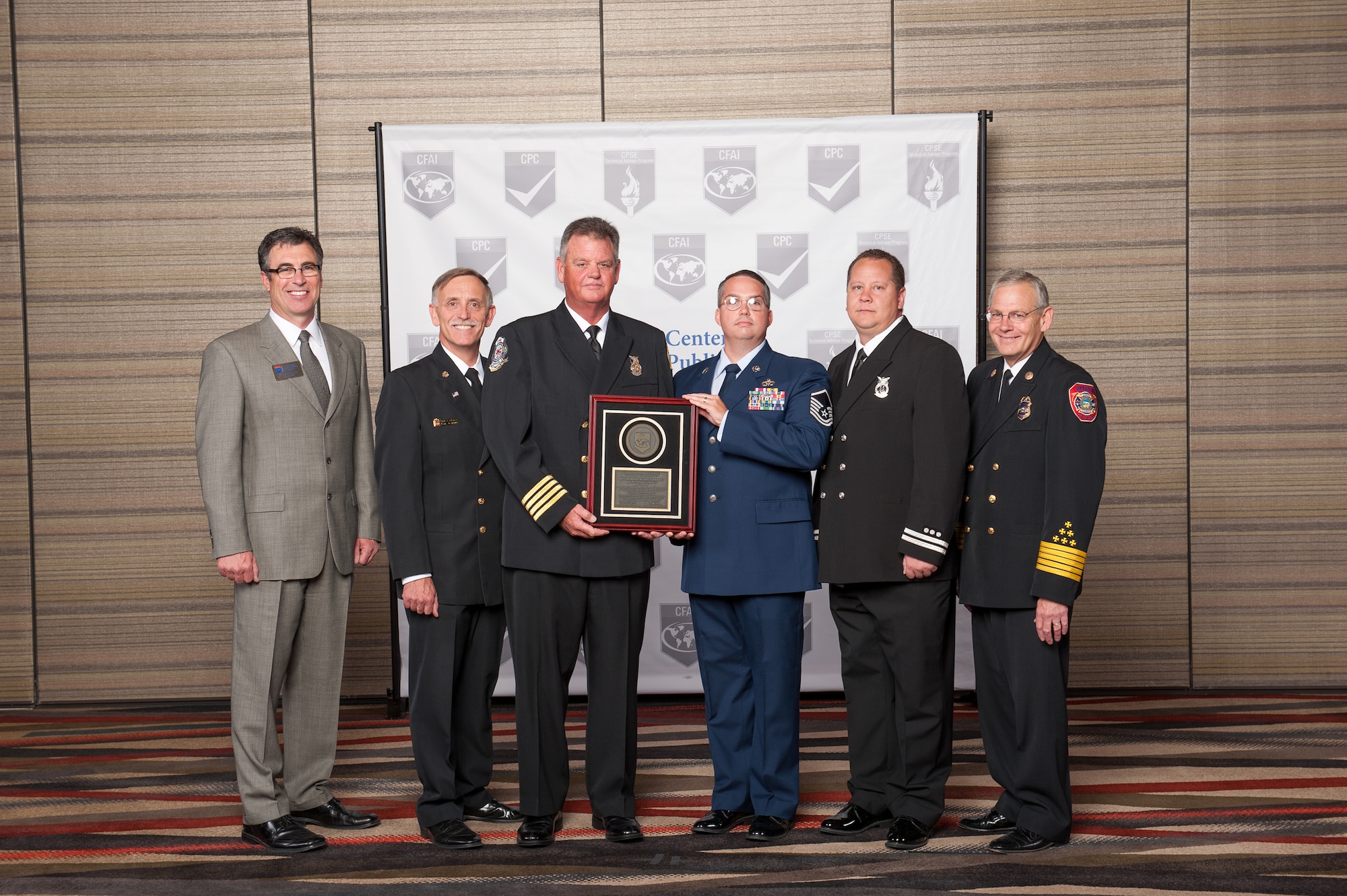 Steven Seward, 23d Civil Engineer Squadron fire chief, left, and U.S. Air Force Master Sgt. Micheal Howell, 23d CES deputy fire chief, right, pose for a photo in Dallas Aug. 14, 2014. Members of the 23d CES attended a two-day conference where they received a Commission on Fire Accreditation International award.(Courtesy photo)