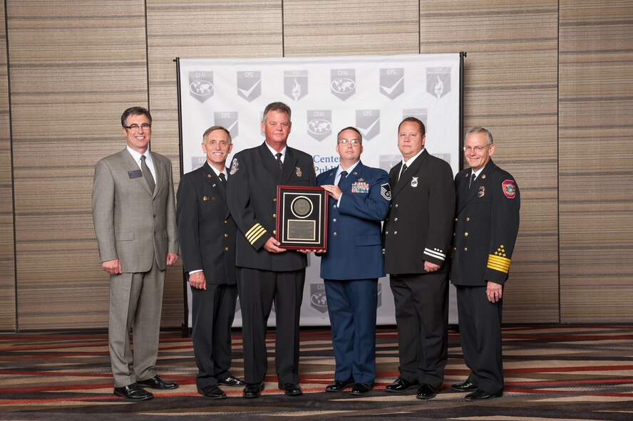 Steven Seward, 23d Civil Engineer Squadron fire chief, left, and U.S. Air Force Master Sgt. Micheal Howell, 23d CES deputy fire chief, right, pose for a photo in Dallas Aug. 14, 2014. Members of the 23d CES attended a two-day conference where they received a Commission on Fire Accreditation International award.(Courtesy photo)